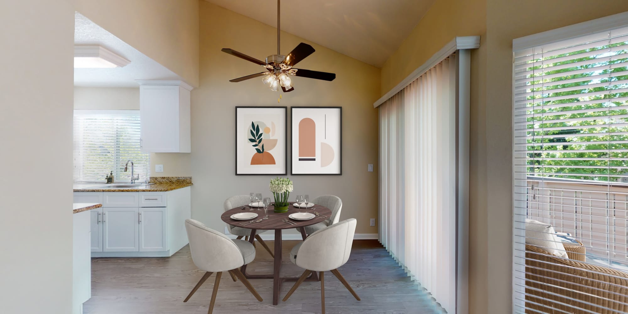 Two-bedroom apartment's dining area with sliding doors and balcony at Valley Plaza Villages in Pleasanton, California