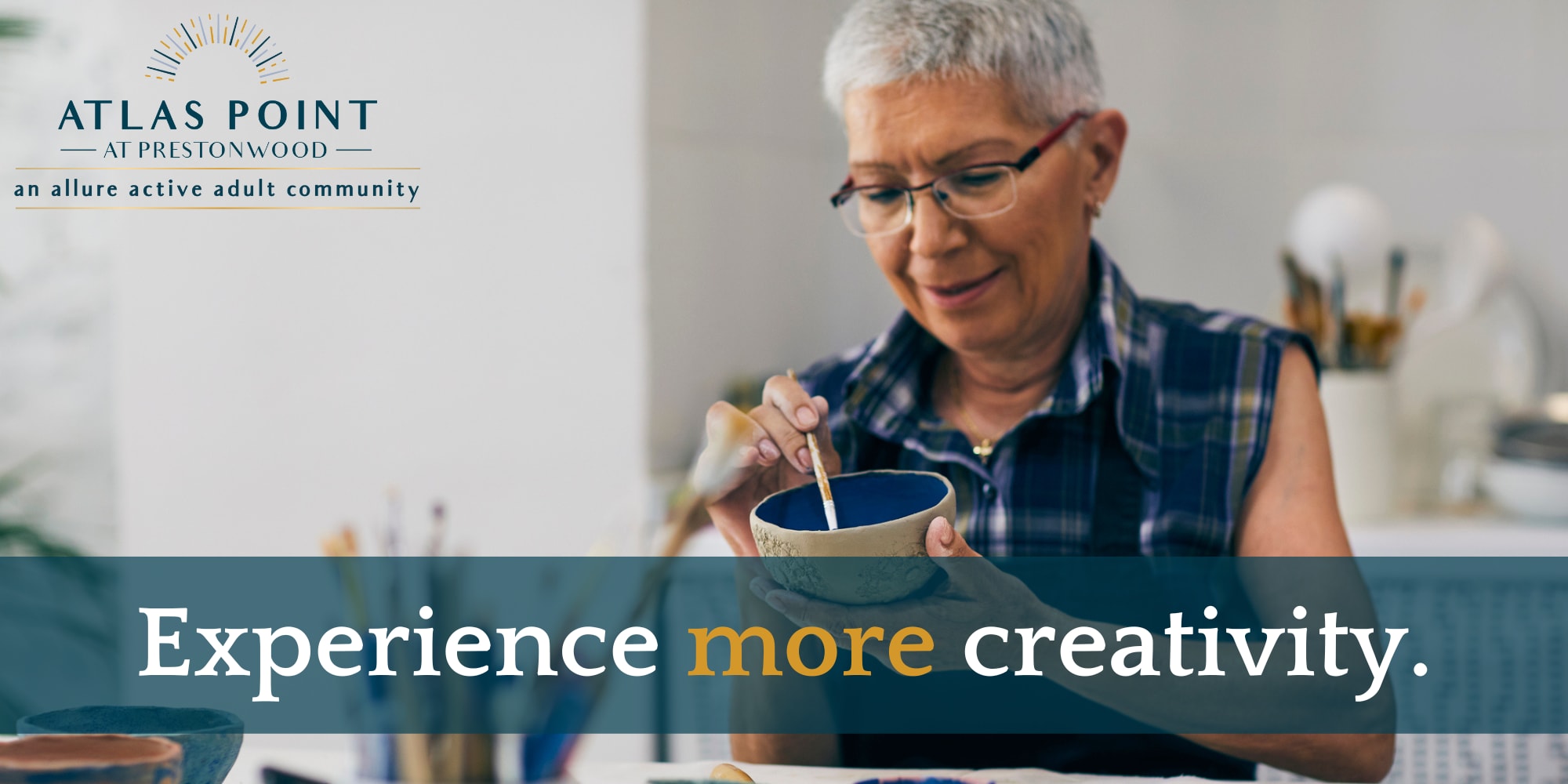 Resident painting a clay bowl at Atlas Point at Prestonwood in Carrollton, Texas.