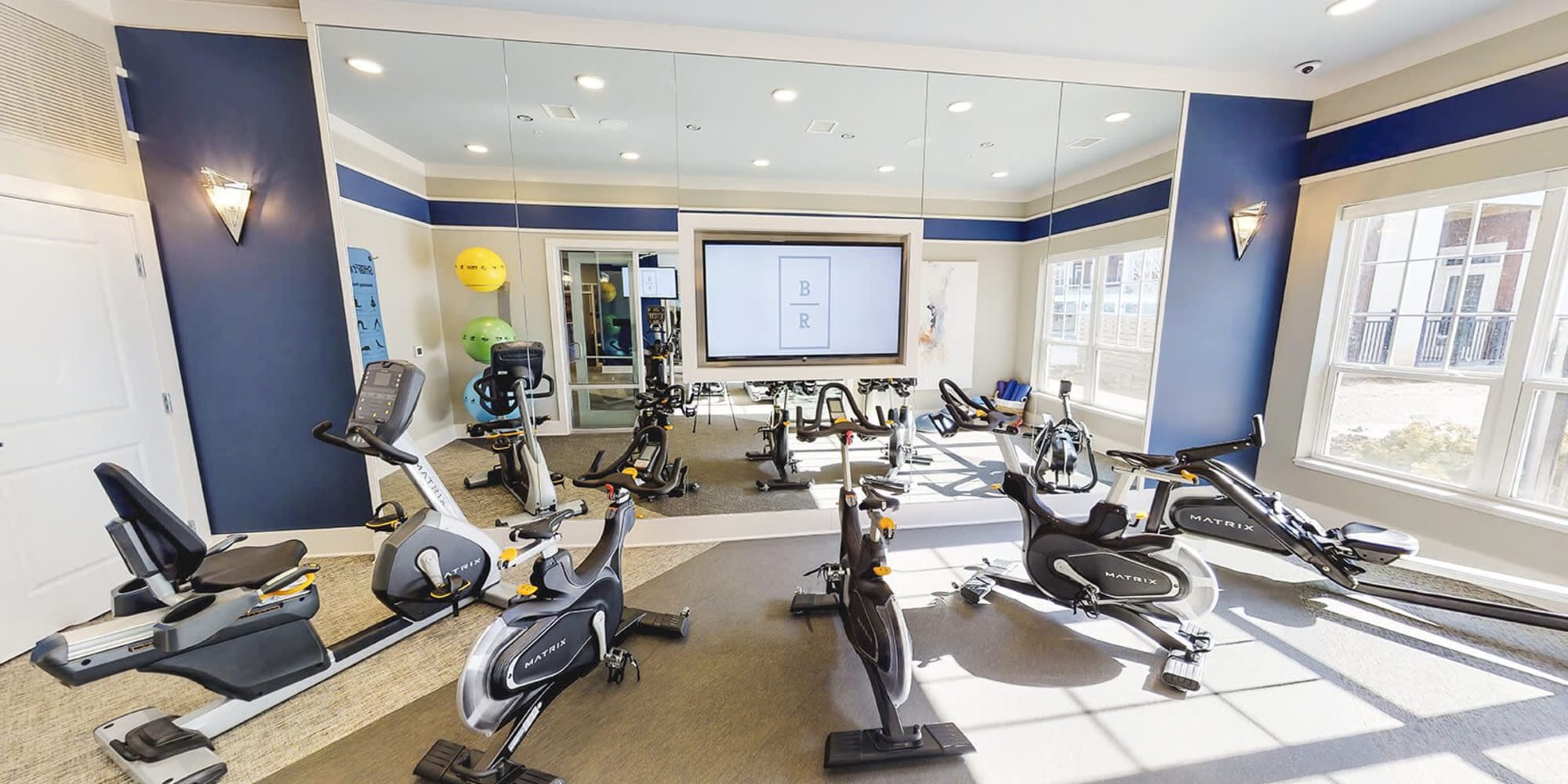 Modern fitness center with a tv screen for group classes at Brookfield Reserve in Brookfield, Wisconsin