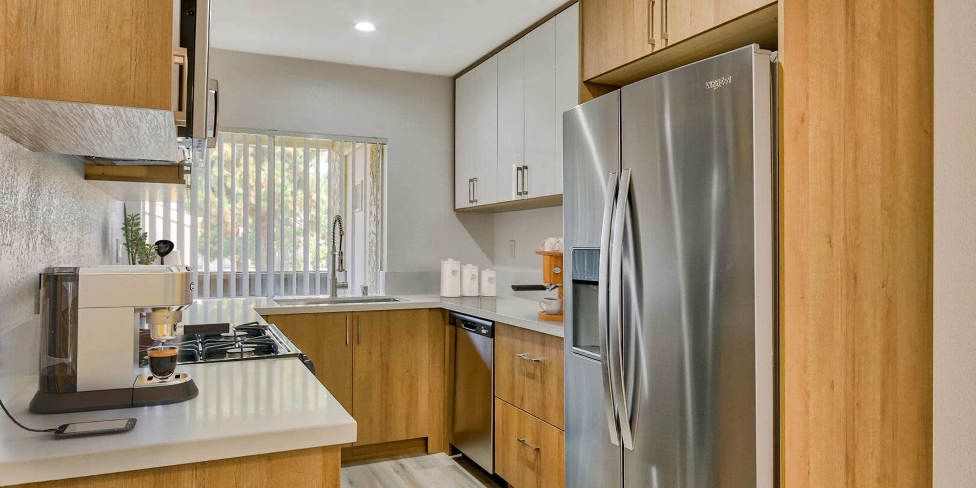 Kitchen and living space at Torrey Pines Apartment Homes in West Covina, California