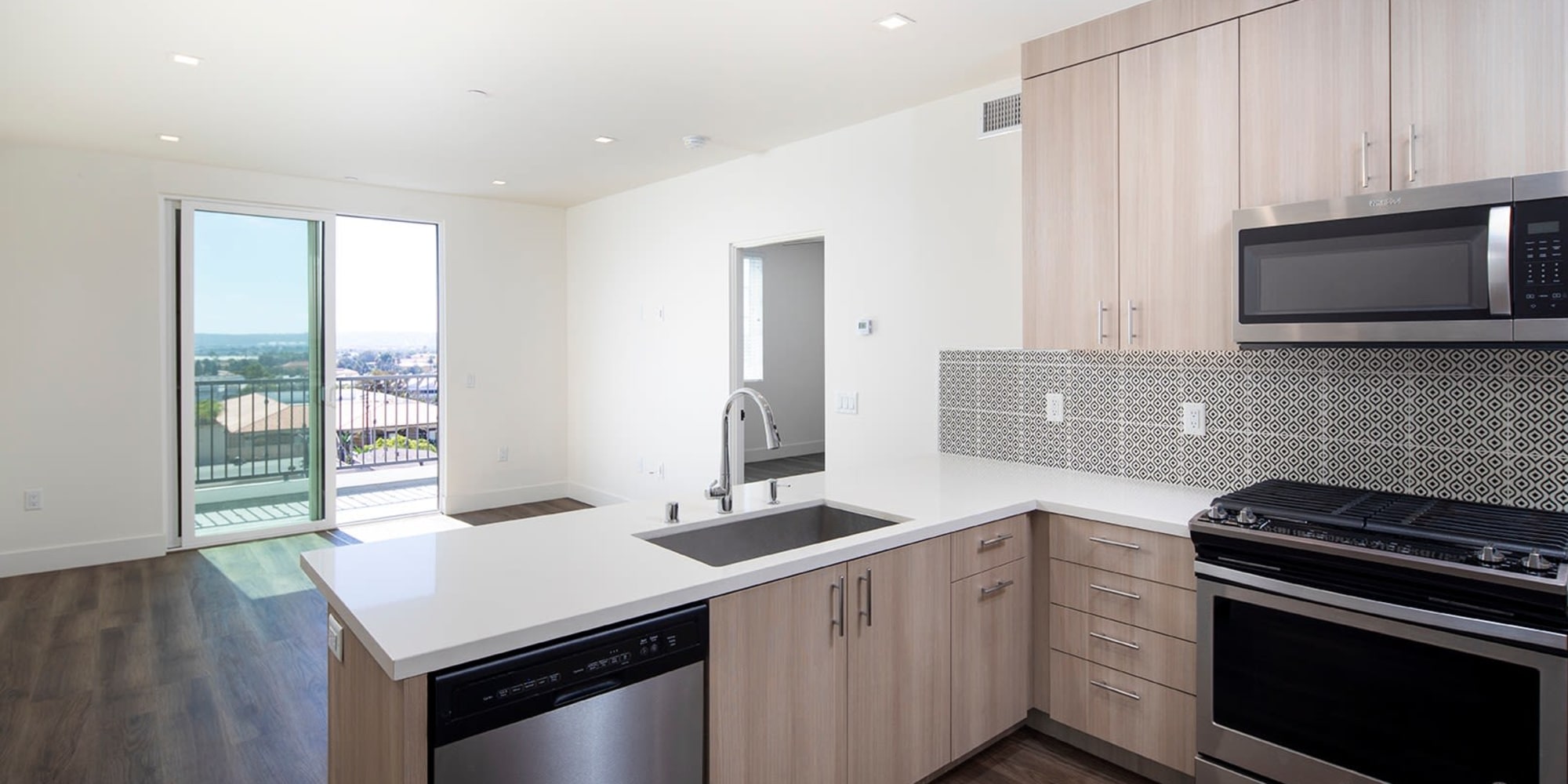 Modern kitchen with upgraded appliances at Mission West Lofts in San Diego, California