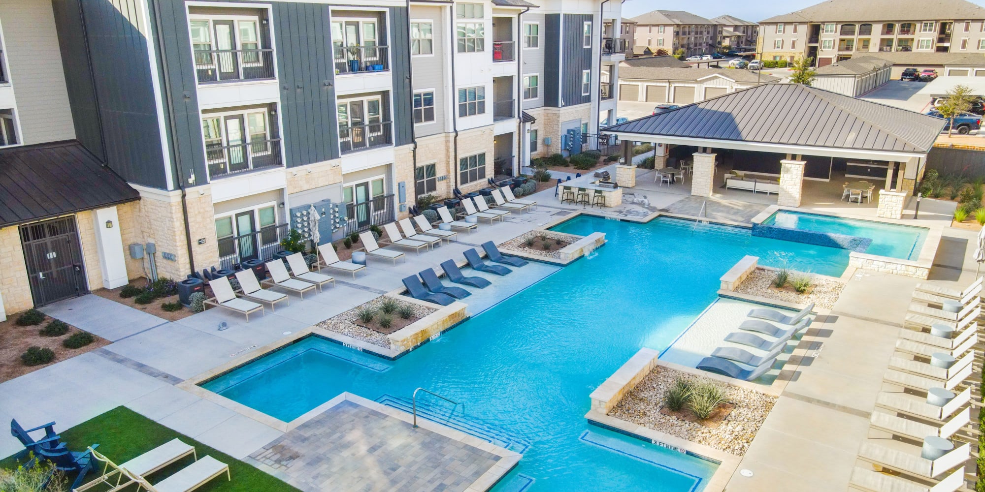 Aerial view of the swimming pool with seating at The Everett at Ally Village in Midland, Texas
