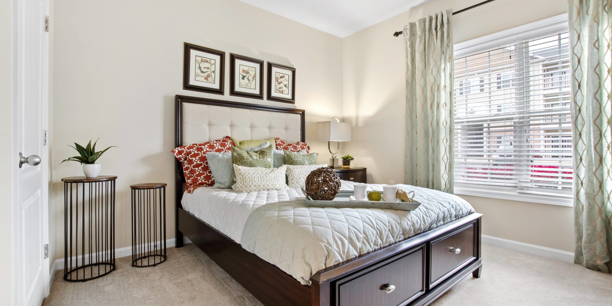 Well-decorated model bedroom with wood accents at Olympus at Jack Britt in Fayetteville, North Carolina