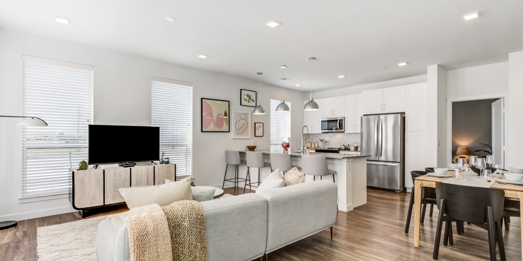 Spacious model living space with gray accents at Mezzo Apartments in Aubrey, Texas