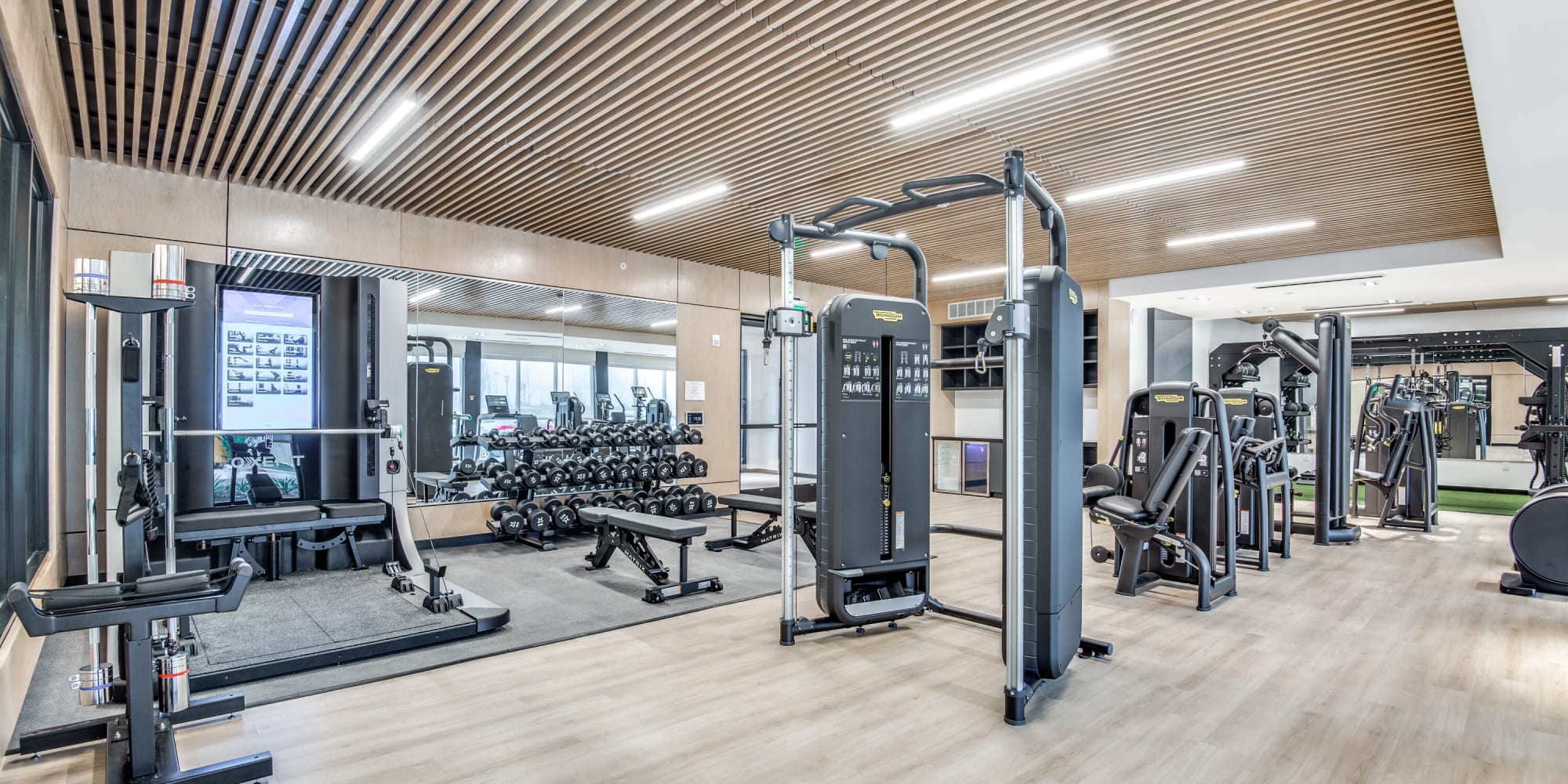 Fitness center with lots of equipment at Mezzo Apartments in Aubrey, Texas