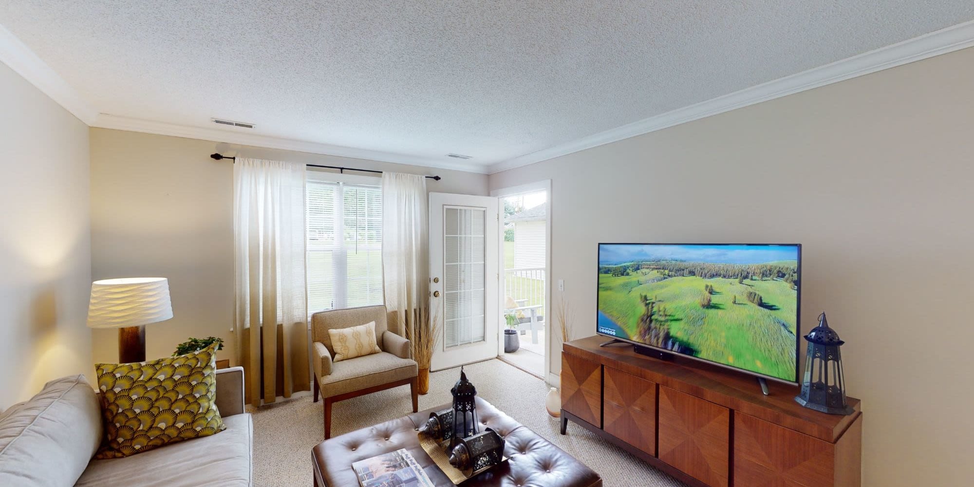 Living room with TV at Brookhaven Apartments in Lancaster, New York