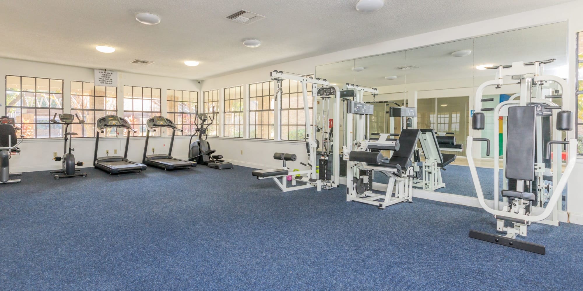 Orlando, FL Apartments with In-Unit Washer and Dryer - Millenium Cove - State-Of-The-Art Fitness Center with Strength Training equipment, Large Mirrors, and Large Windows