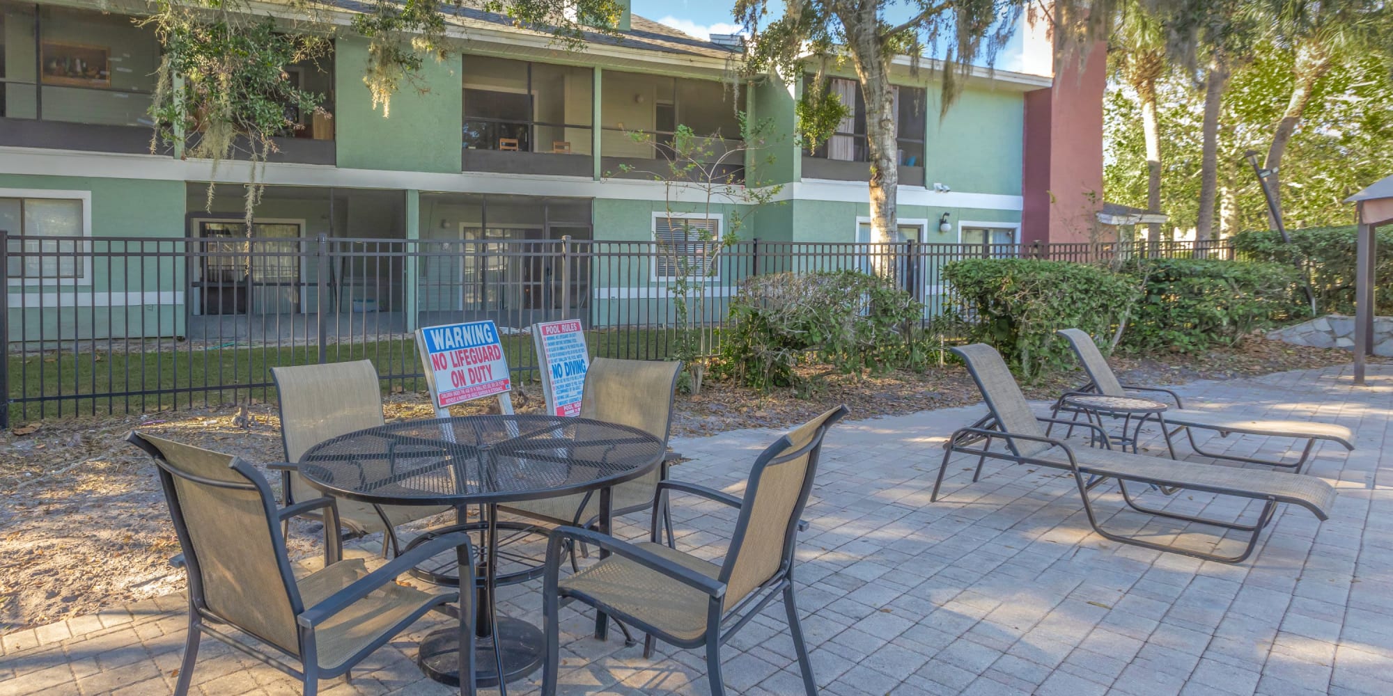 Picnic tables and chairs by the pool at Stone Creek at Wekiva in Altamonte Springs, Florida