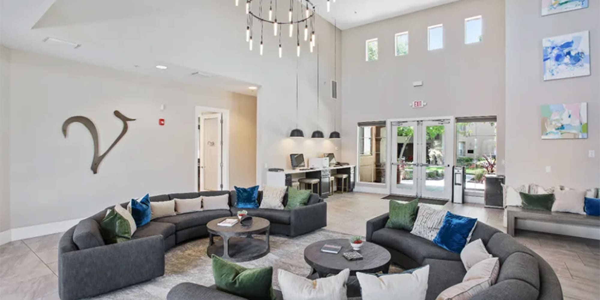 Lounge area with oversized sofas and cathedral ceilings in the clubhouse at Villagio Luxury Apartments in Sacramento, California