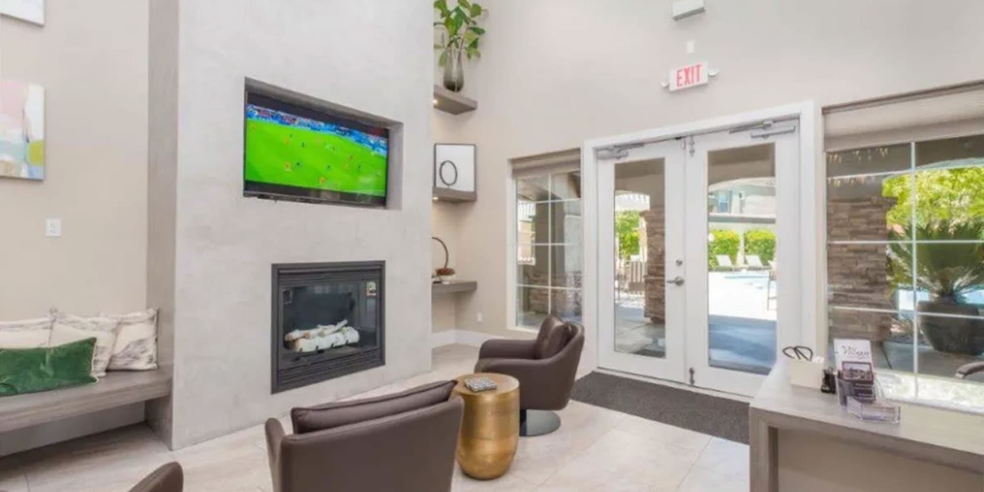 Fireplace and large flatscreen TV in the resident clubhouse at Villagio Luxury Apartments in Sacramento, California