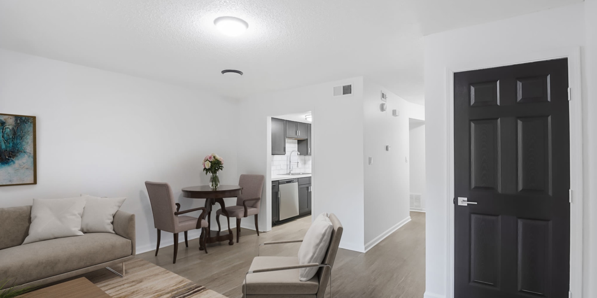 Living room leading to a kitchen and storage closet at The Palmiere in Pensacola, Florida