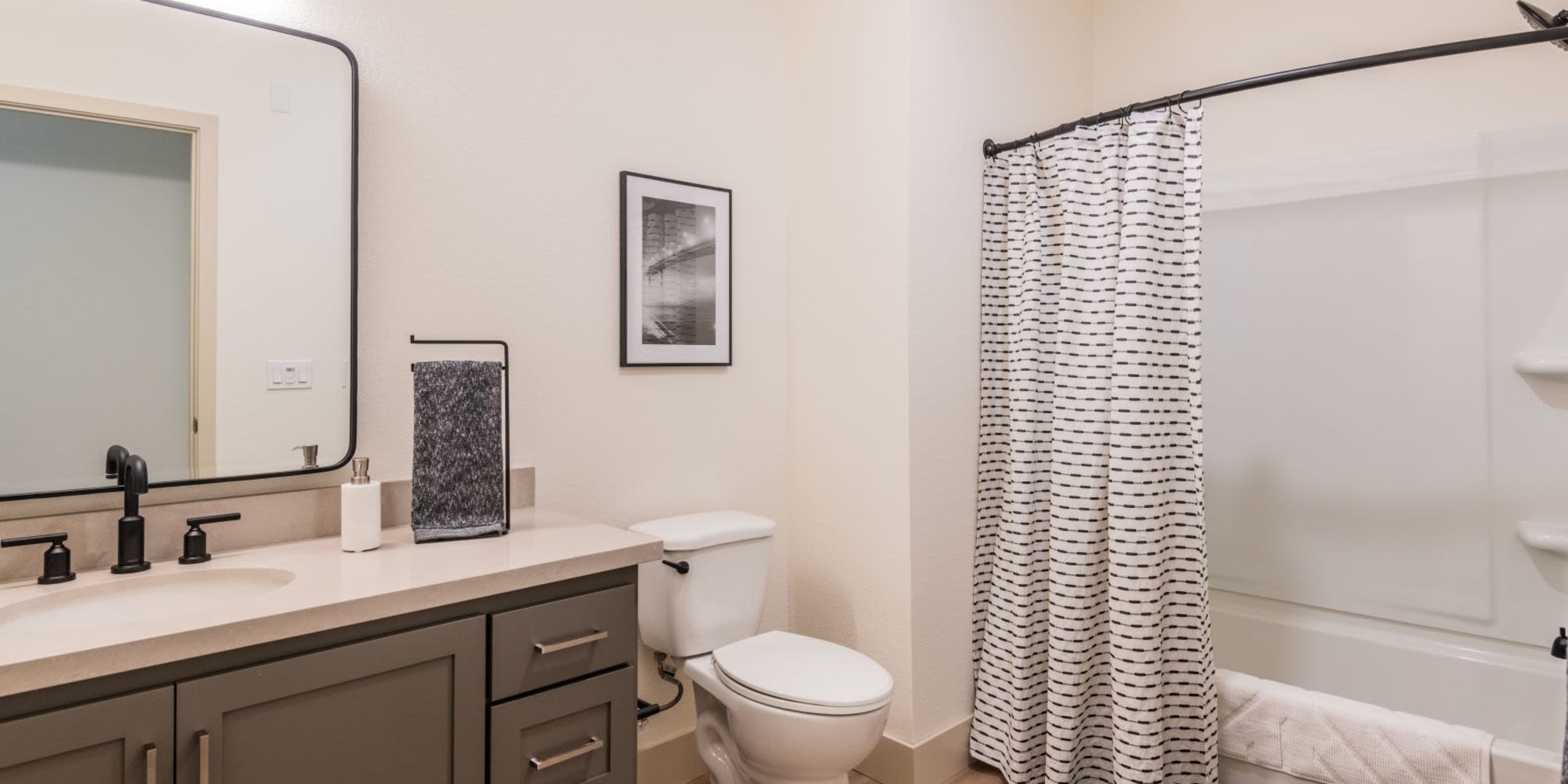 Bathroom with tub and shower at Towne Centre Apartments in Lathrop, California
