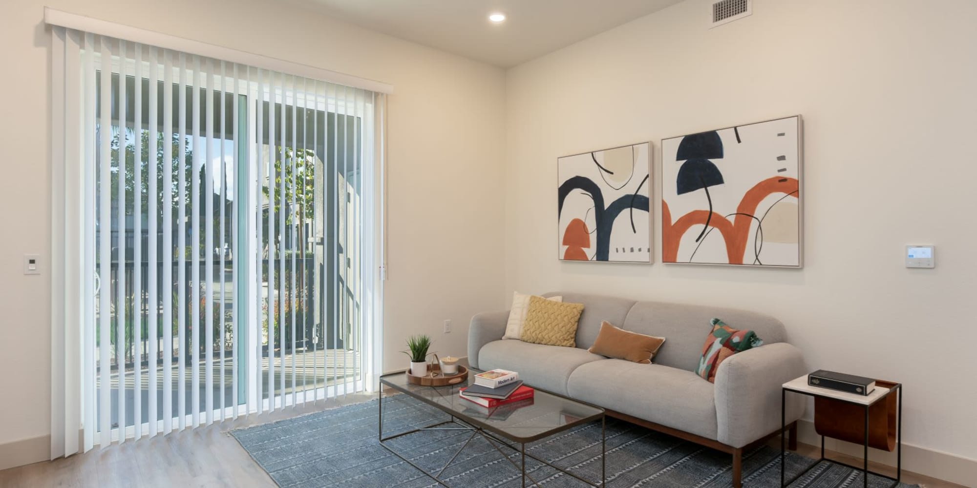Living room with doors to patio or balcony at Towne Centre Apartments in Lathrop, California