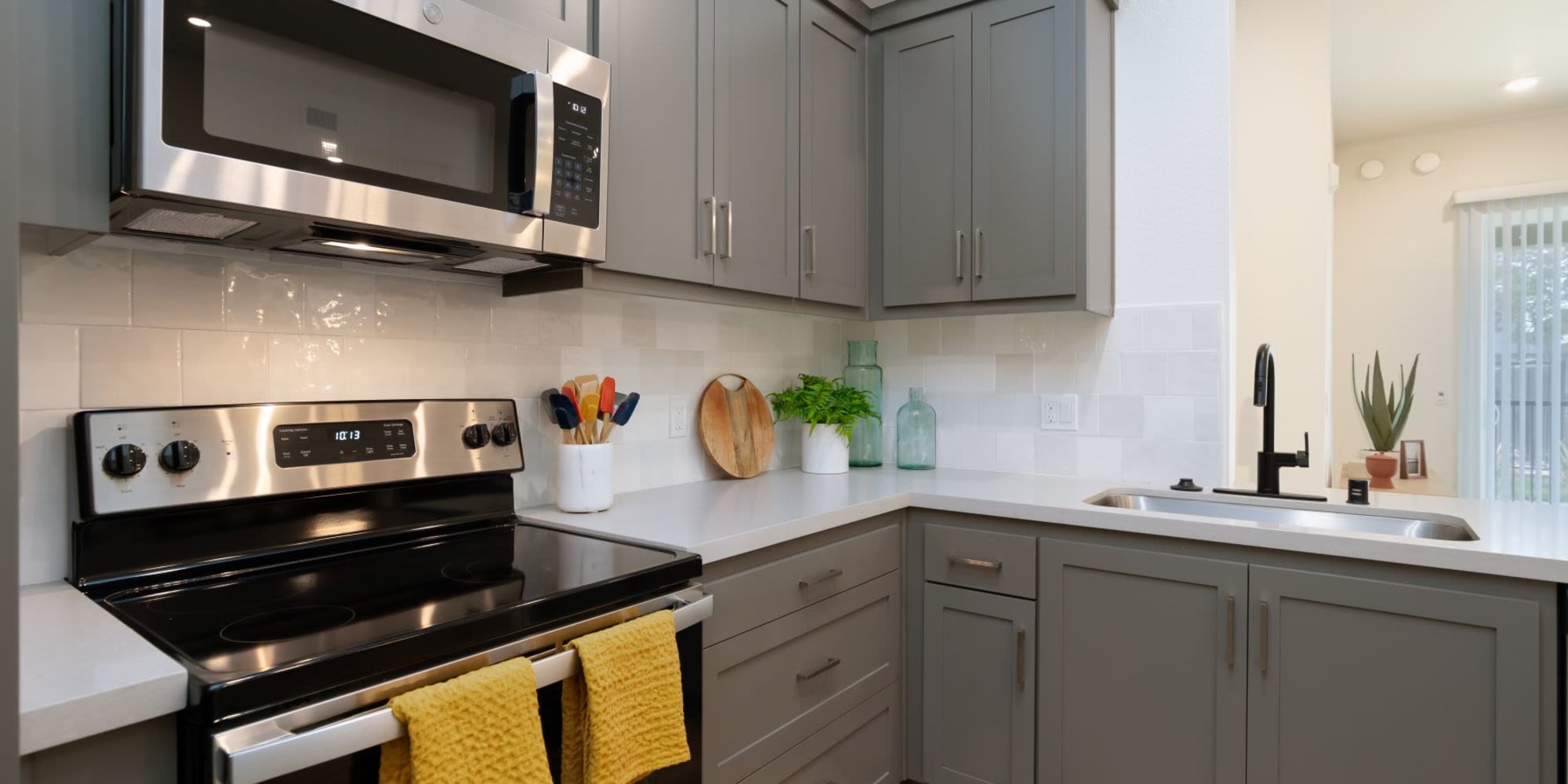 Kitchen with stainless-steel appliances at Towne Centre Apartments in Lathrop, California