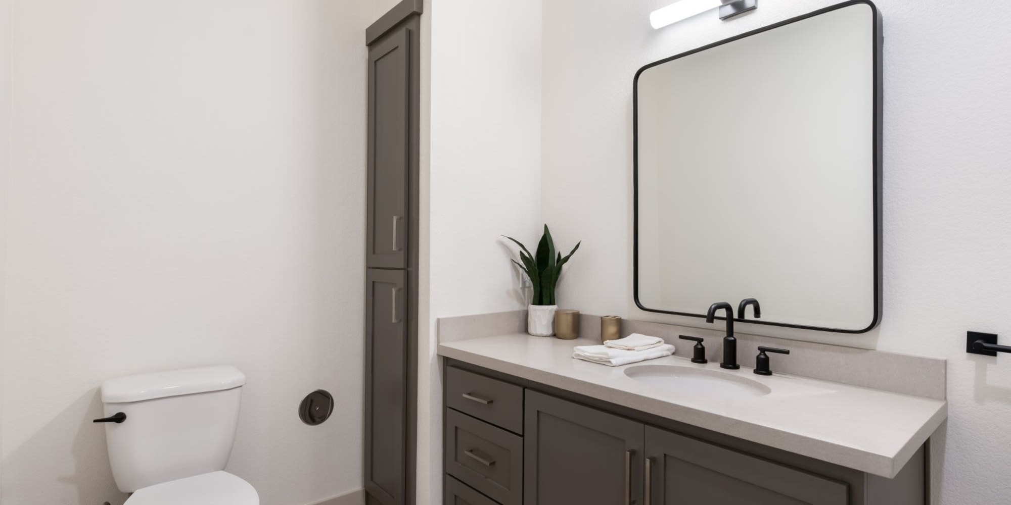 Bathroom with cabinets at Towne Centre Apartments in Lathrop, California
