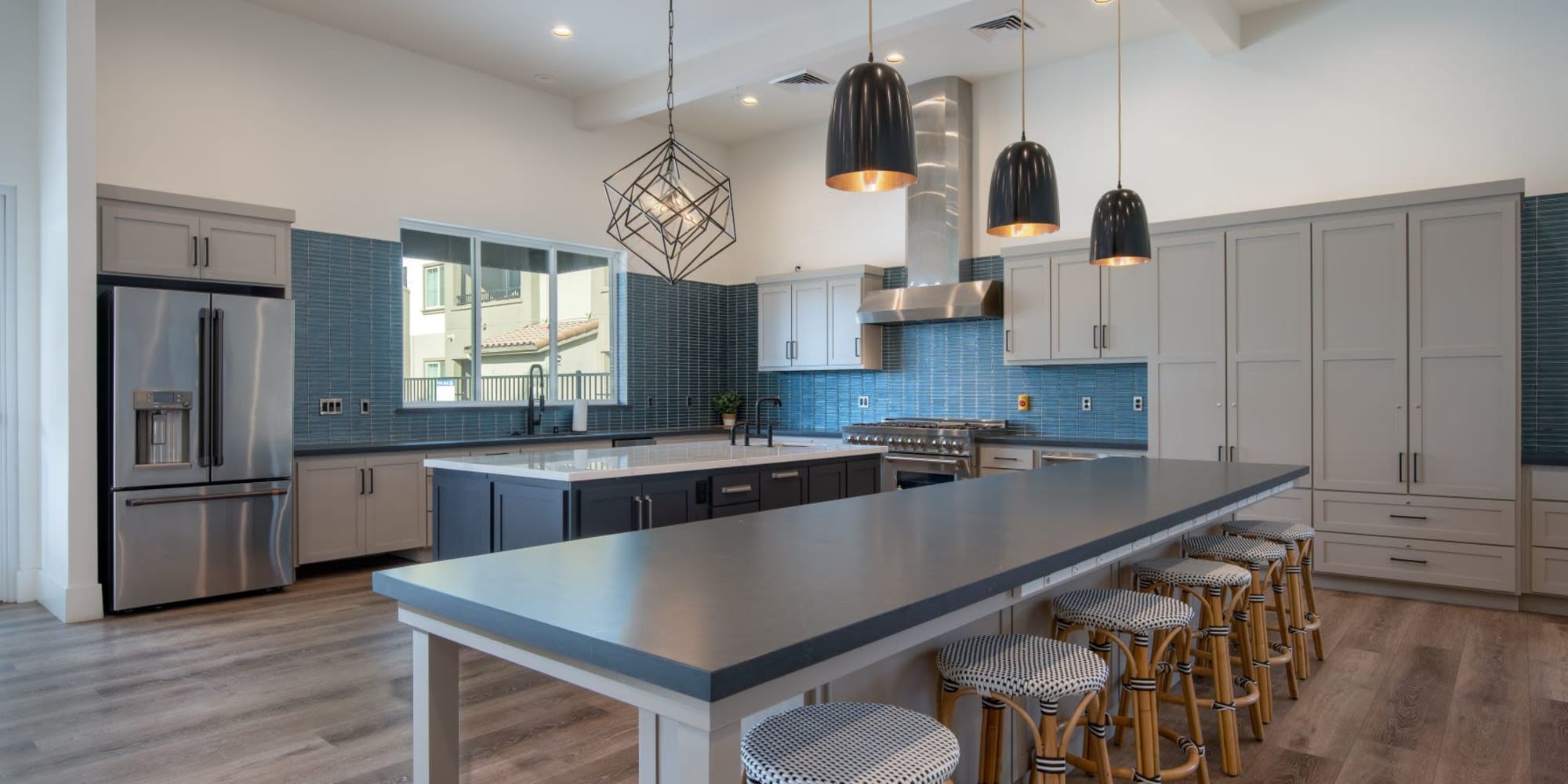 Kitchen with bar seating in the resident lounge at Towne Centre Apartments in Lathrop, California
