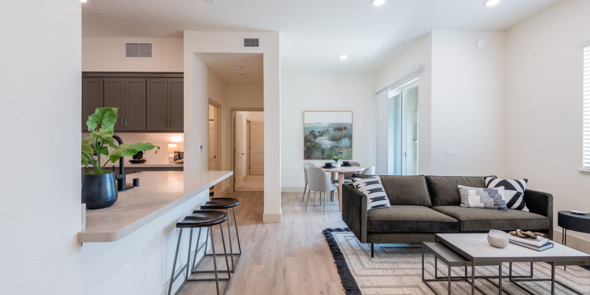 Spacious living room with wood-style flooring at Towne Centre Apartments in Lathrop, California