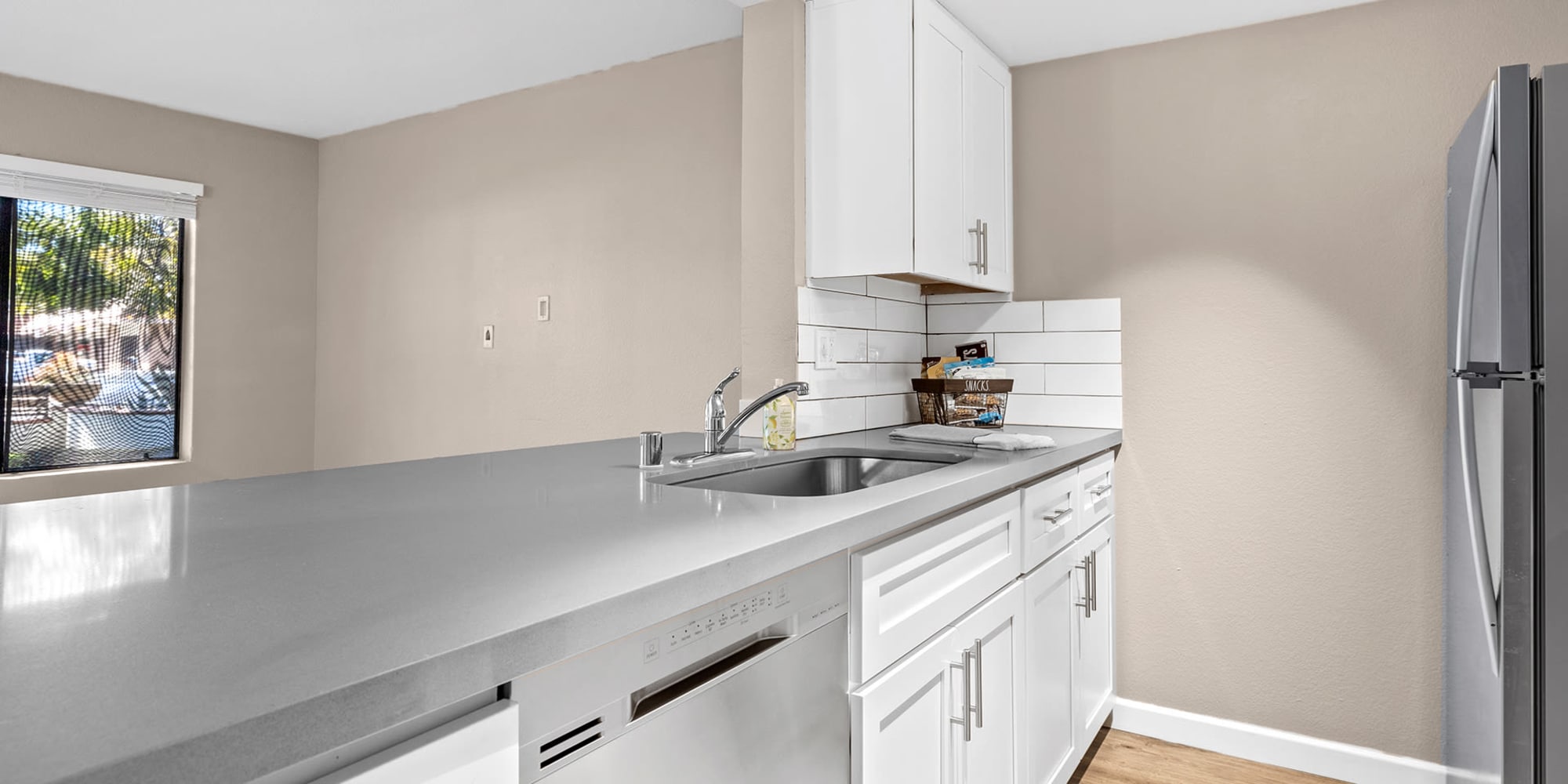 Kitchen with updated appliances at Trails at Grand Terrace in Colton, California