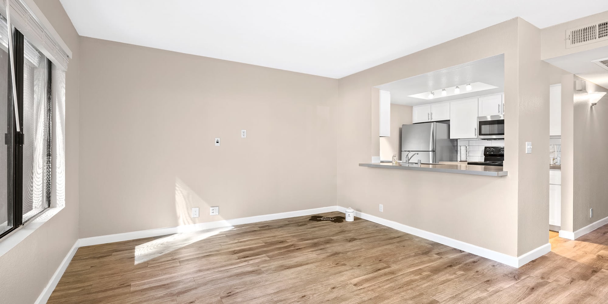 Spacious apartment with wood-style flooring at Trails at Grand Terrace in Colton, California