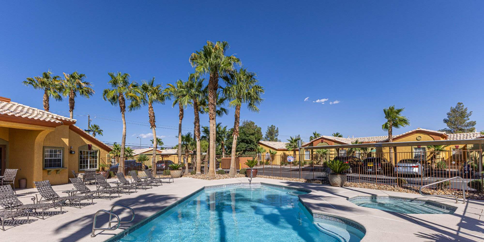Large resident pool with tall trees at La Serena at the Parque in North Las Vegas, Nevada