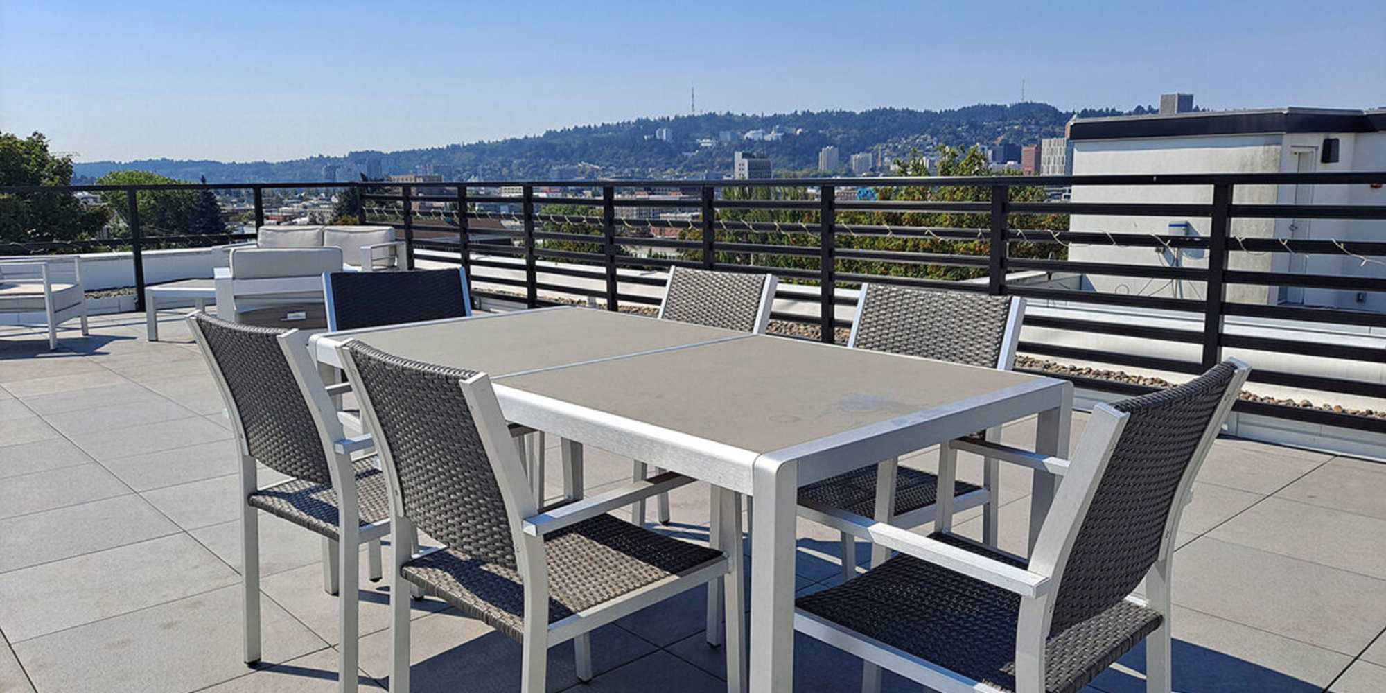 Table and chairs on the rooftop deck at Koz on 13th in Portland, Oregon