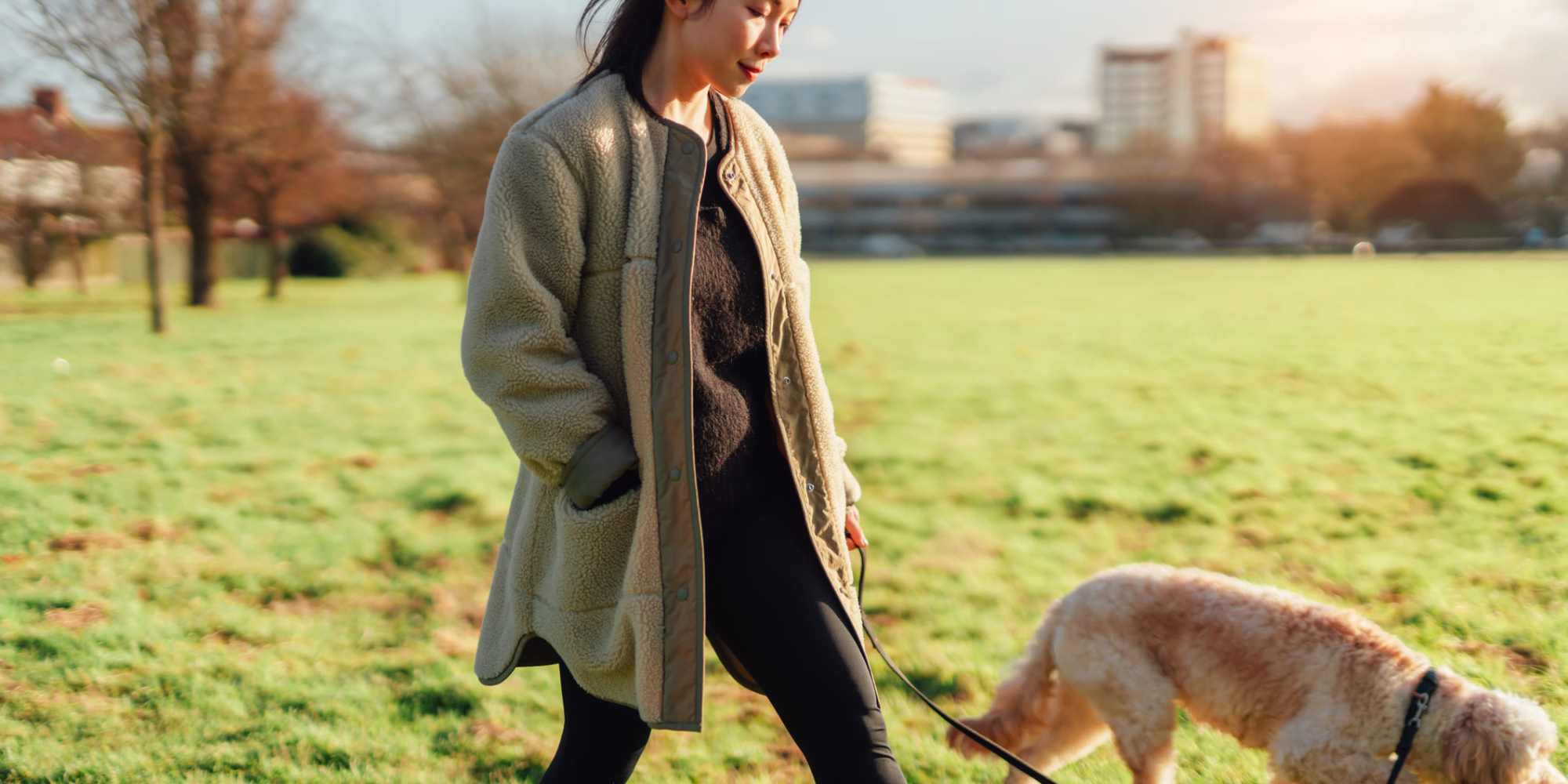 Resident walking with her dog near Magnolia Creek Apartments in Tulsa, Oklahoma