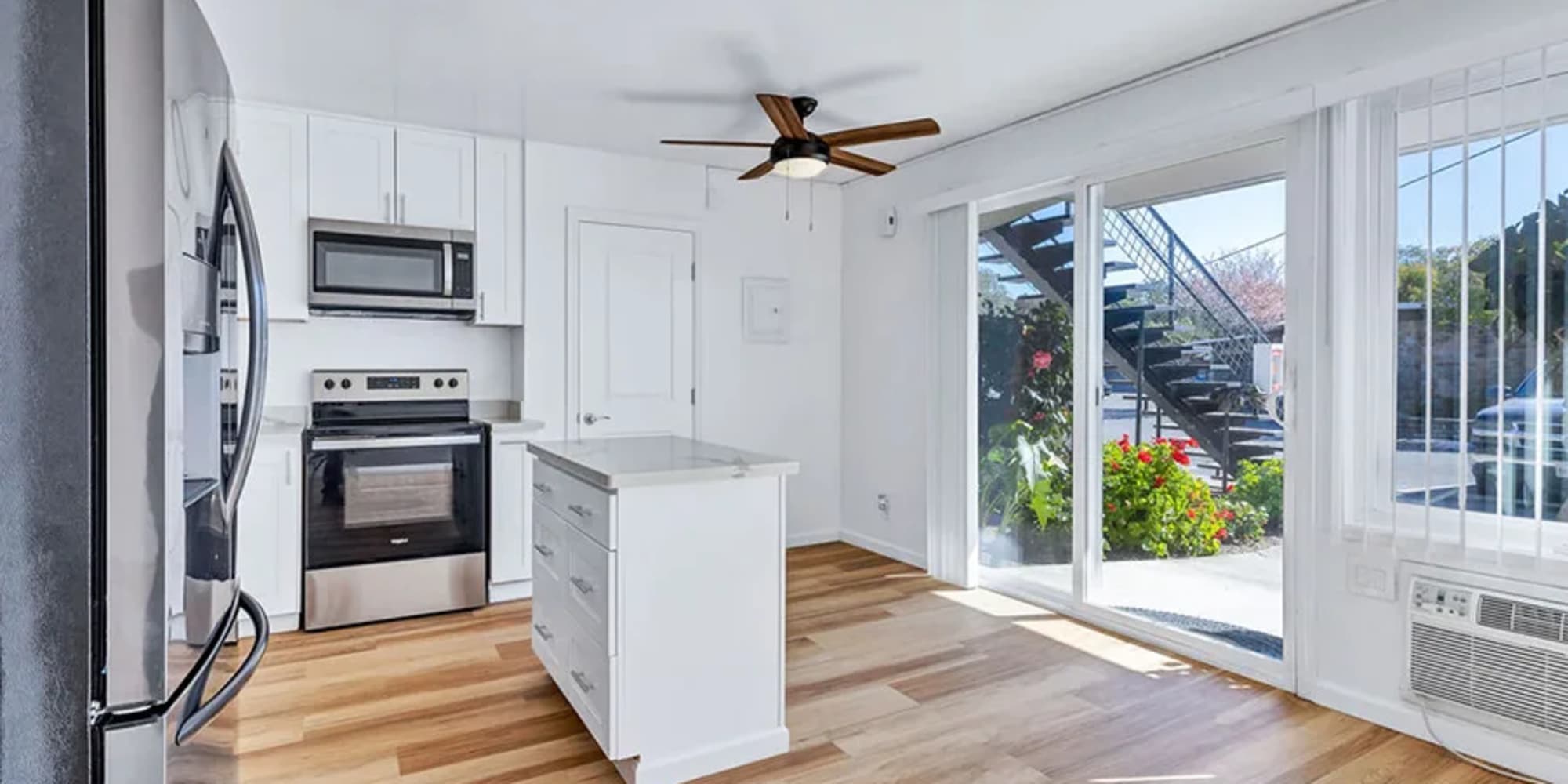 An apartment kitchen near sliding glass doors to the patio at Silverado Gardens in Napa, California
