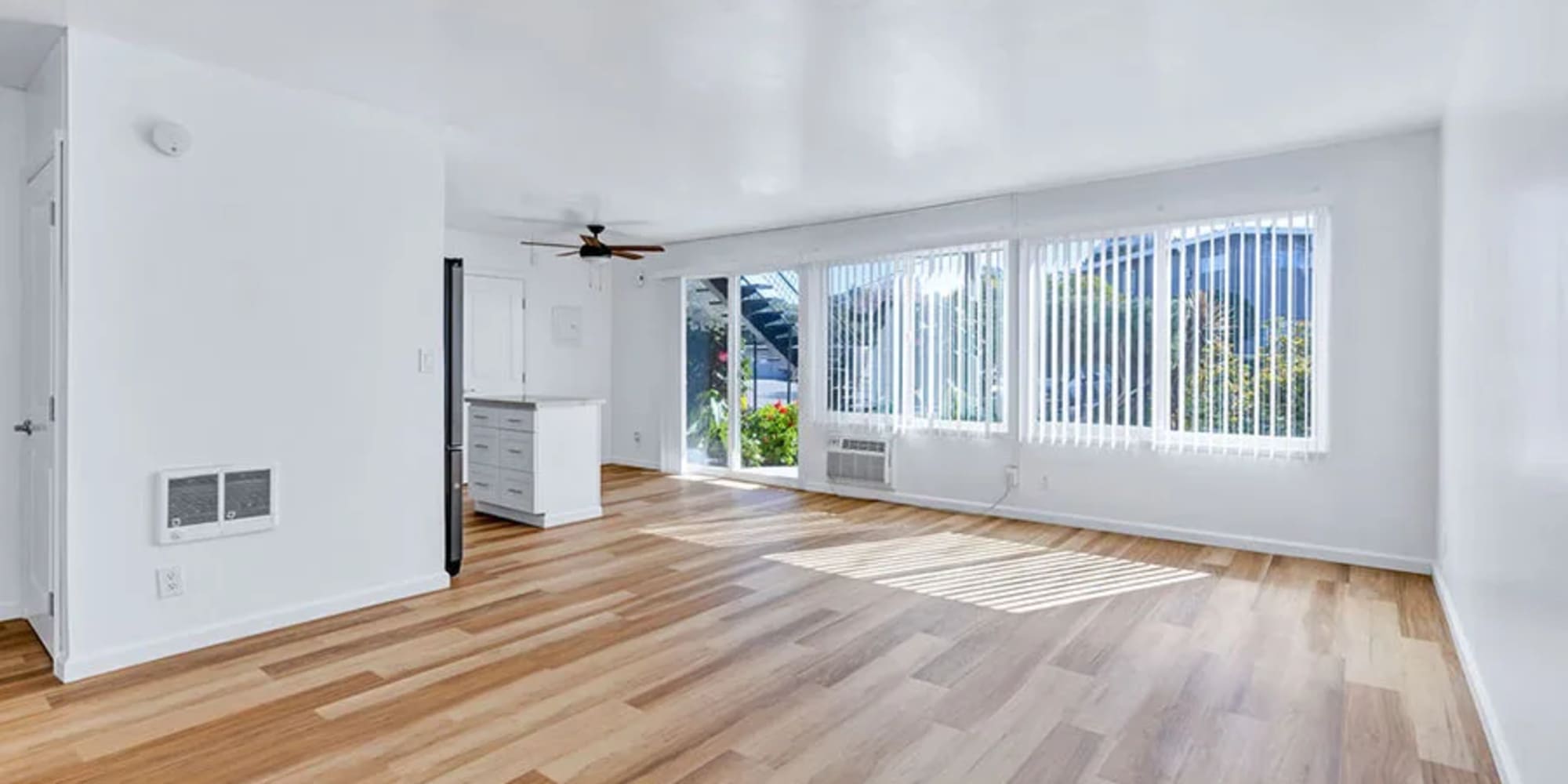 Wood flooring and large windows in an apartment living room at Silverado Gardens in Napa, California