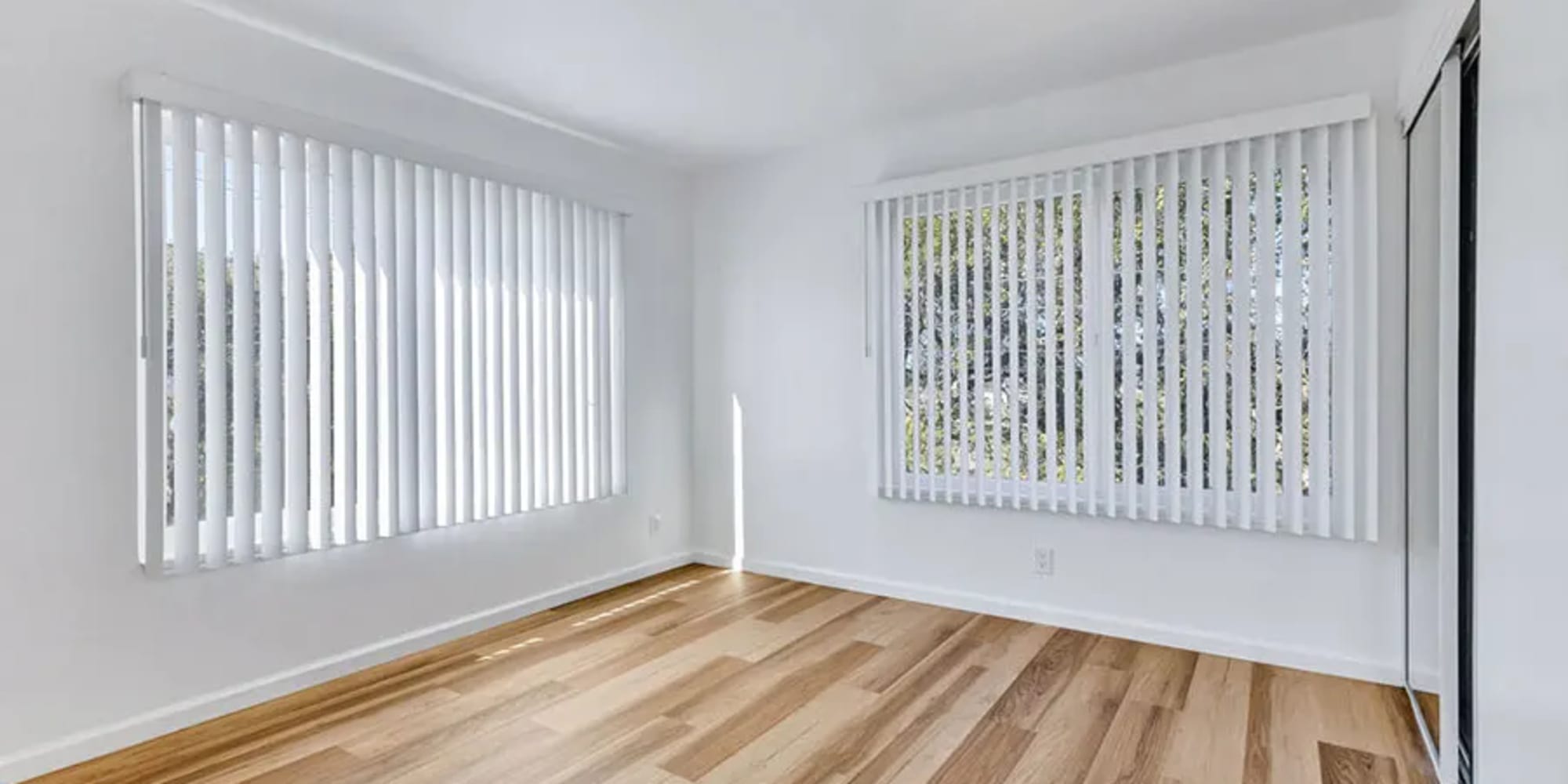 Two large windows with blinds in an apartment bedroom at Silverado Gardens in Napa, California
