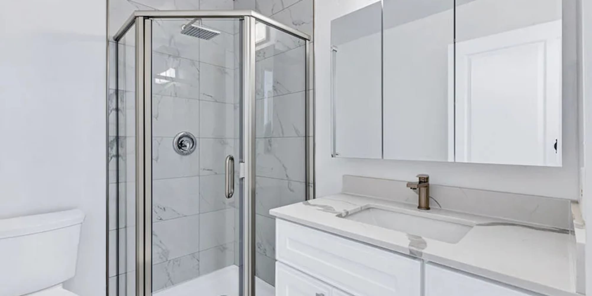 An apartment bathroom with a glass door to the shower at Silverado Gardens in Napa, California