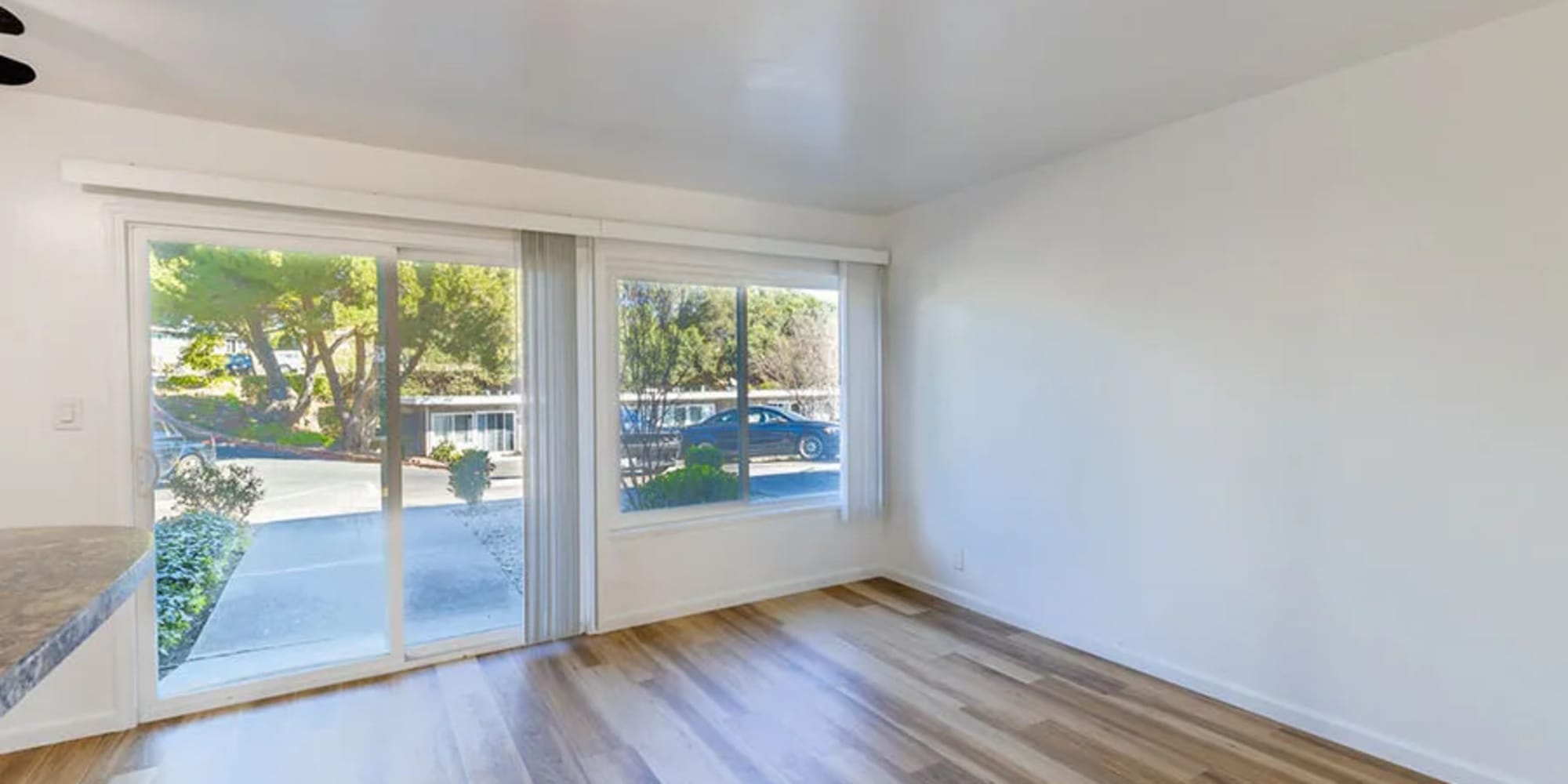 A sliding glass door to the patio from an apartment living room at Silverado Gardens in Napa, California