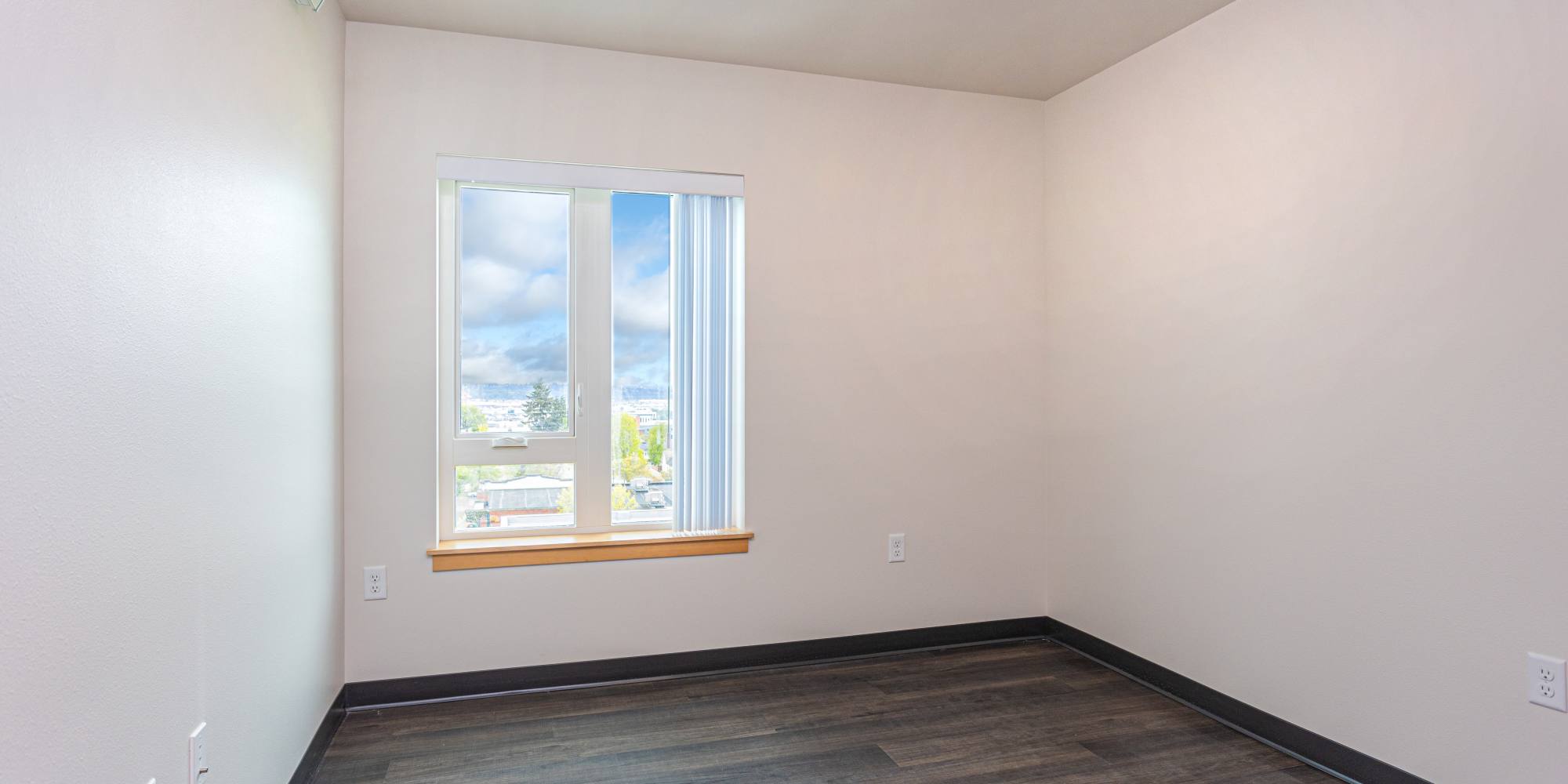 Spacious Bedroom with windows at Housing Hilltop in Tacoma, Washington