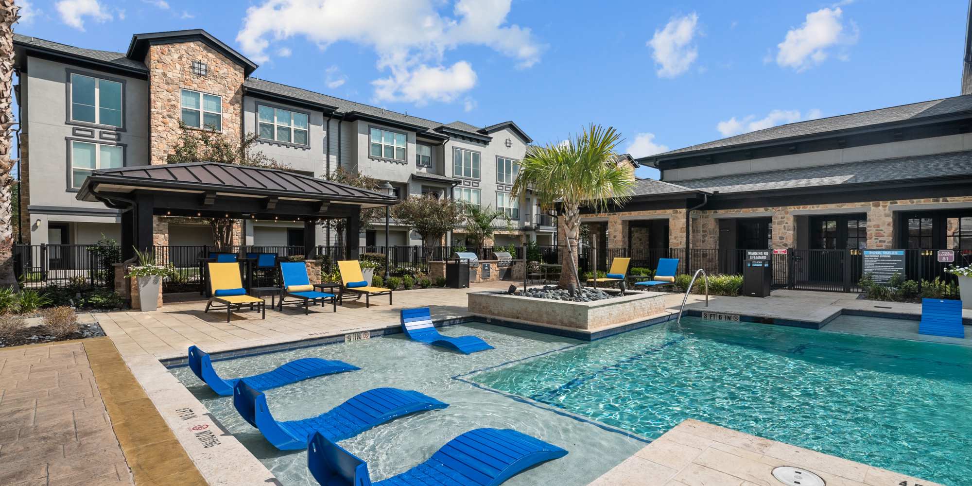 Lounge chairs in the swimming pool at Arrabella in Houston, Texas