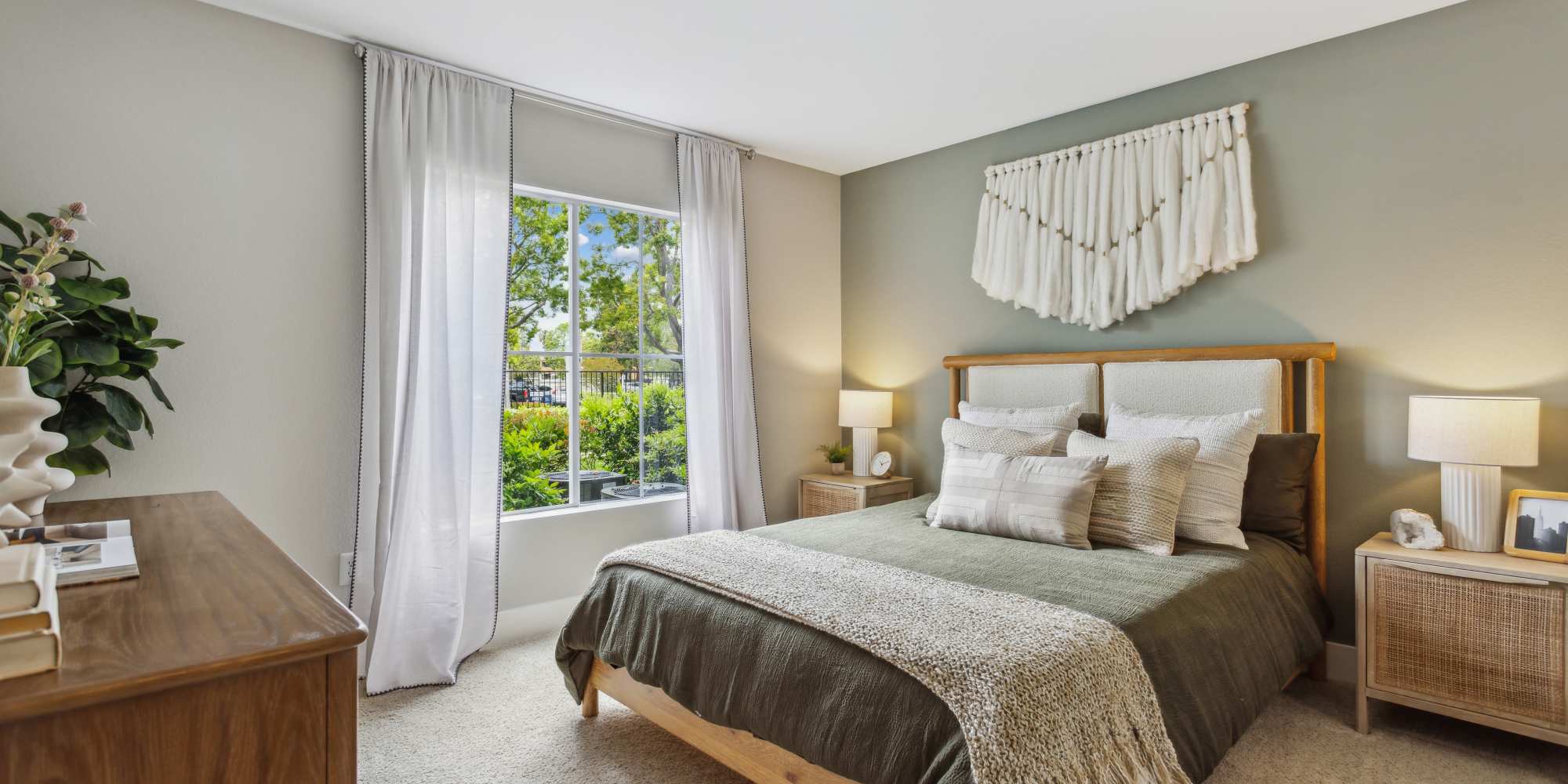 Cozy bedroom with plush carpeting in a model home at Avery at Moorpark in Moorpark, California