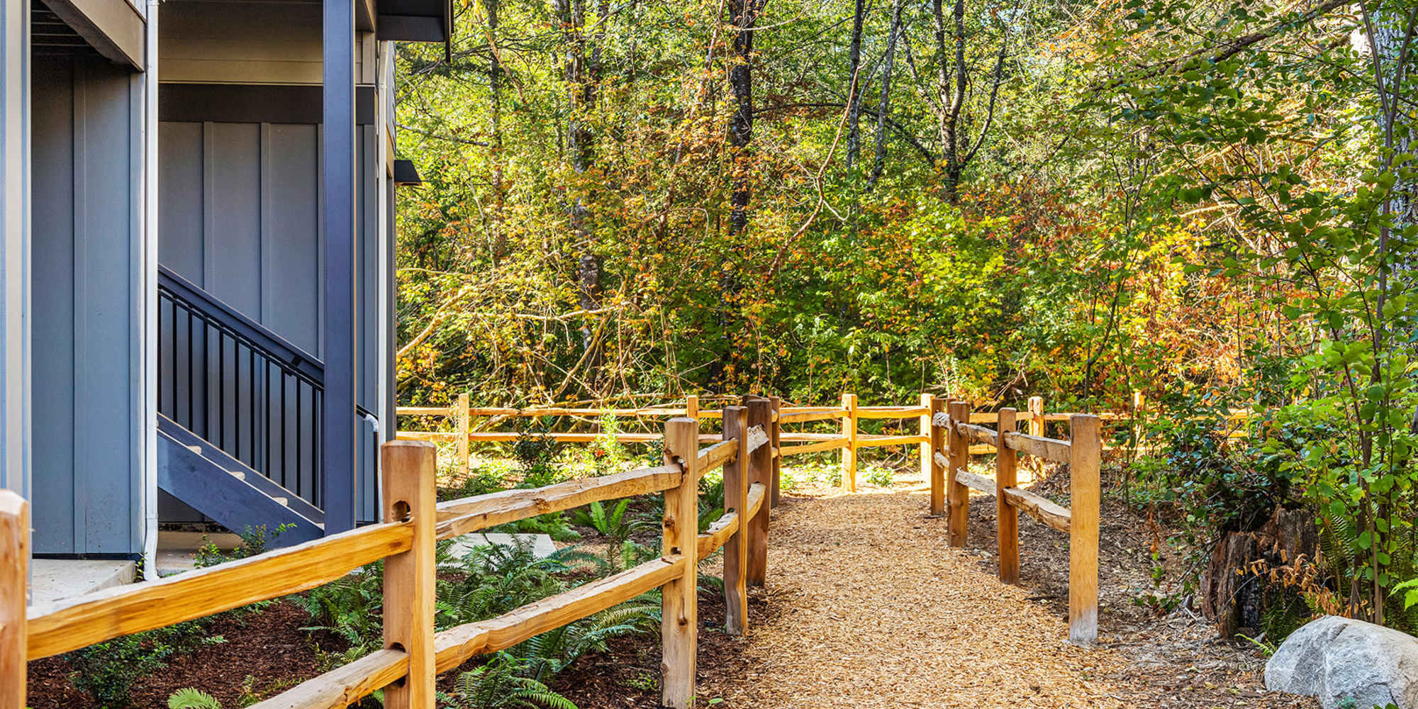 South Hill, WA Apartments for Rent - Alder Walk - Walking Trail with Trees, Plants, and Natural Wood Fence.