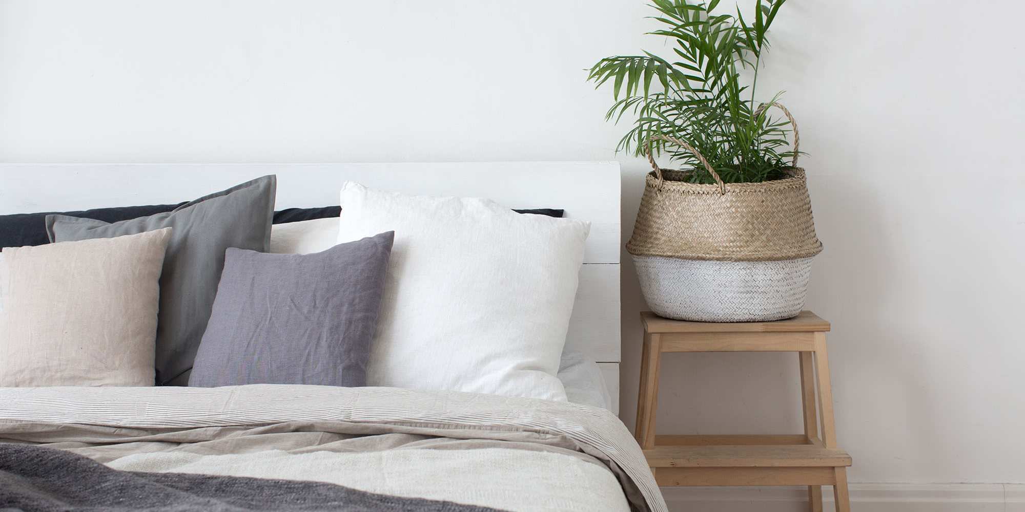 A well-made bed and side table in a bedroom at Copper Steppe in Parker, Colorado