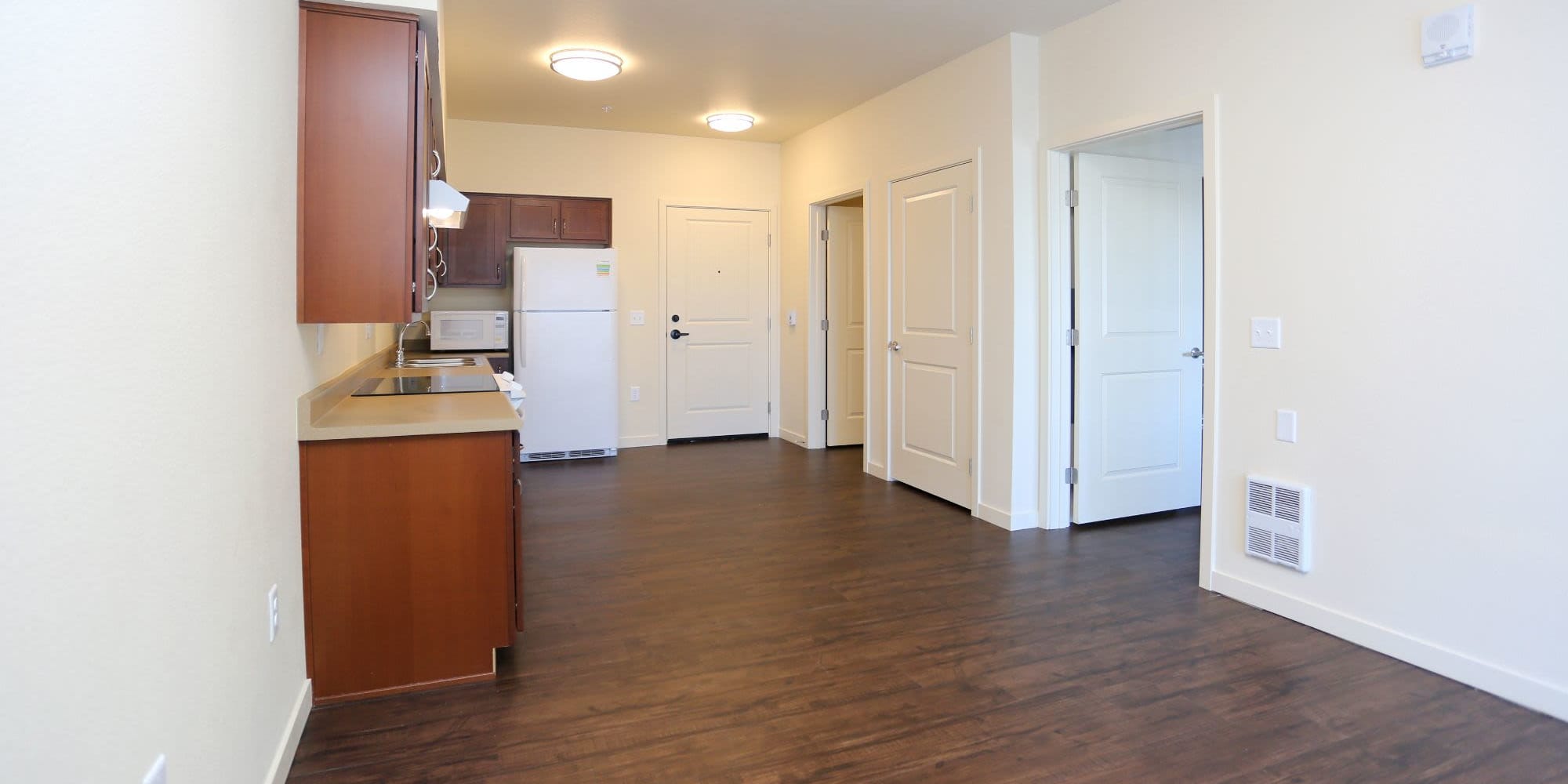 Model living room with hardwood floors at Traditions at Colorado Springs in Colorado Springs, Colorado