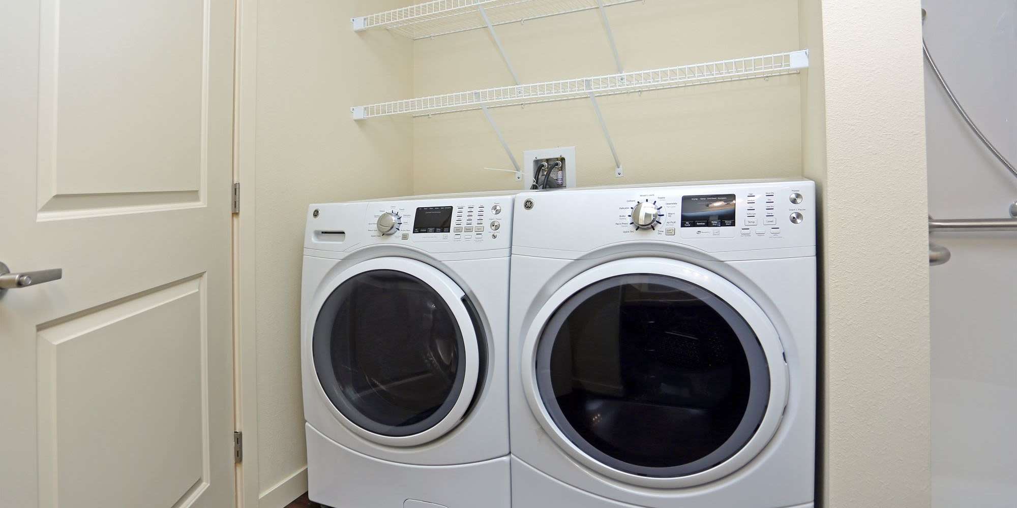 Washer and dryer with extra storage at Traditions at Colorado Springs in Colorado Springs, Colorado