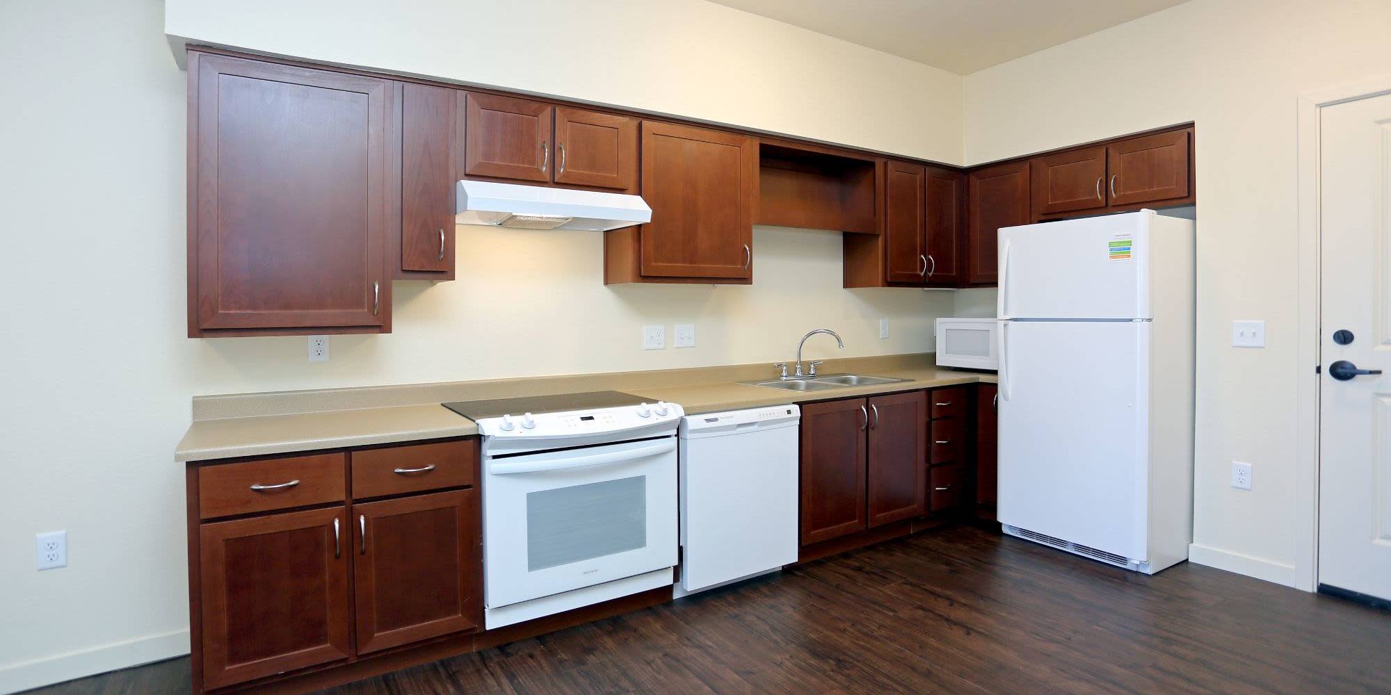 Kitchen with white appliances at Traditions at Colorado Springs in Colorado Springs, Colorado