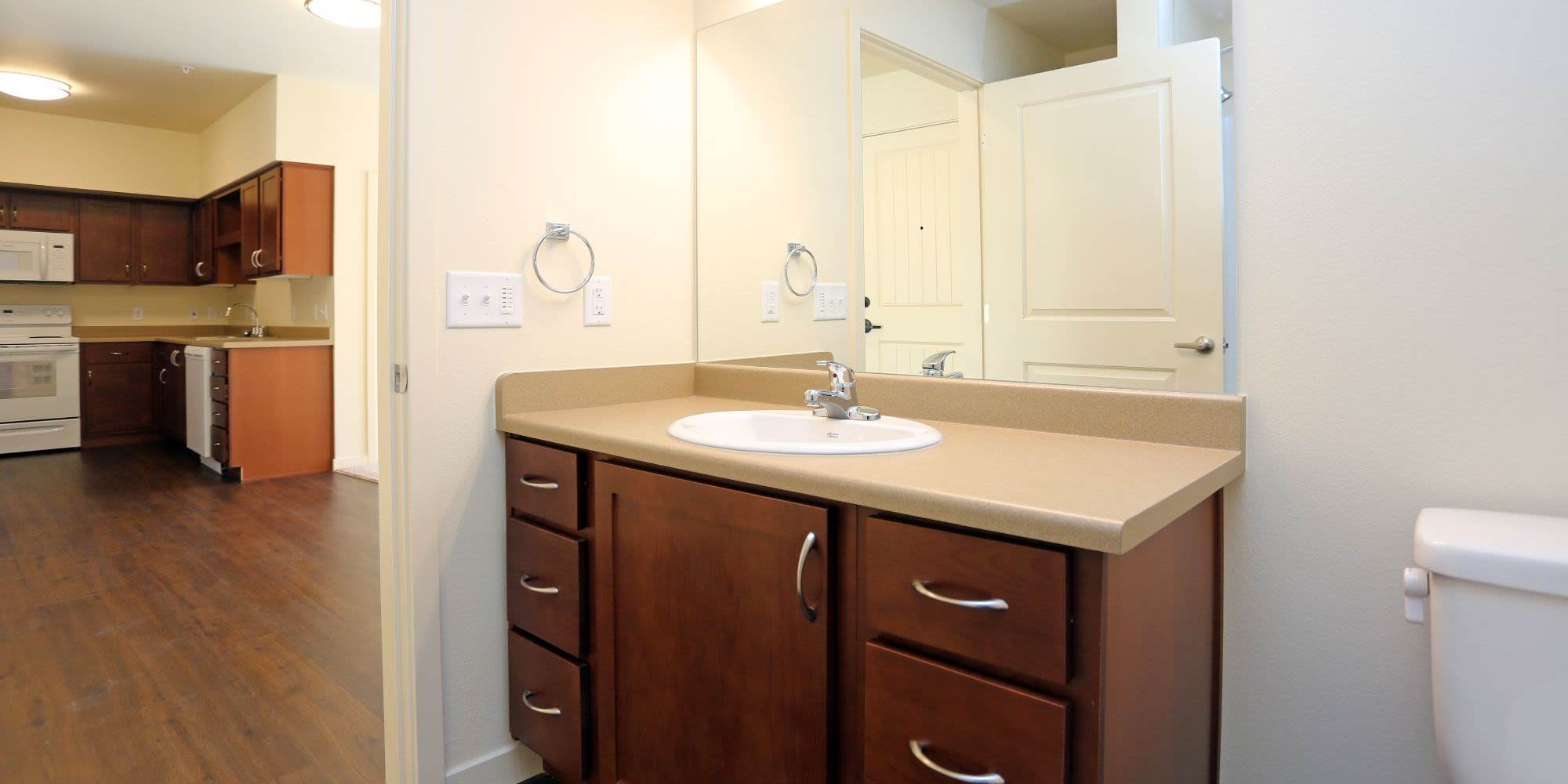 Bathroom with hard flooring, waterfall faucet sink, and storage space at 