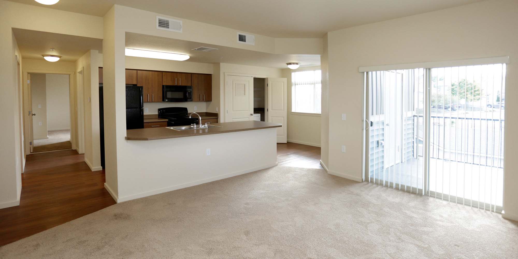 Carpeted living room and kitchen at Copper Creek in Colorado Springs, Colorado