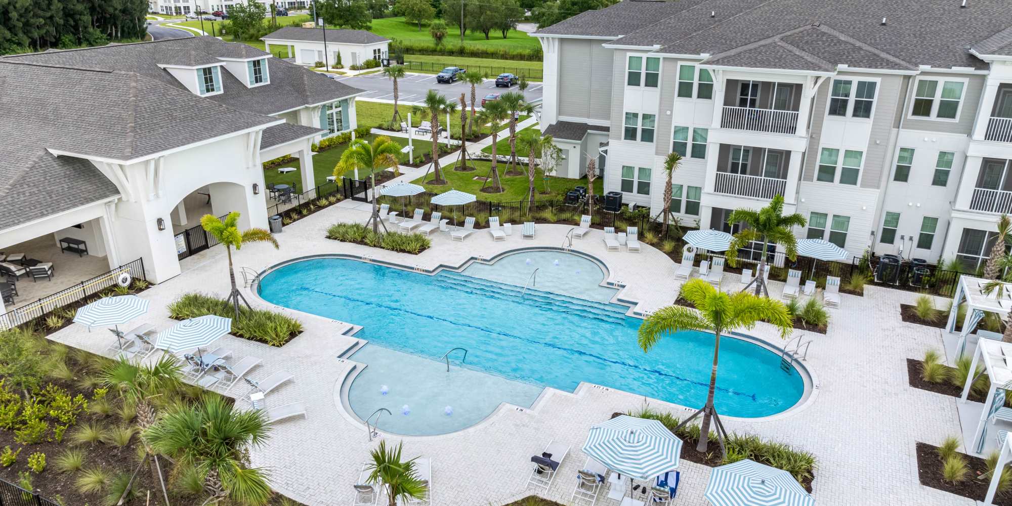 Sparkling resort-style swimming pool and poolside seating at The Griffon Vero Beach | Apartments in Vero Beach, Florida