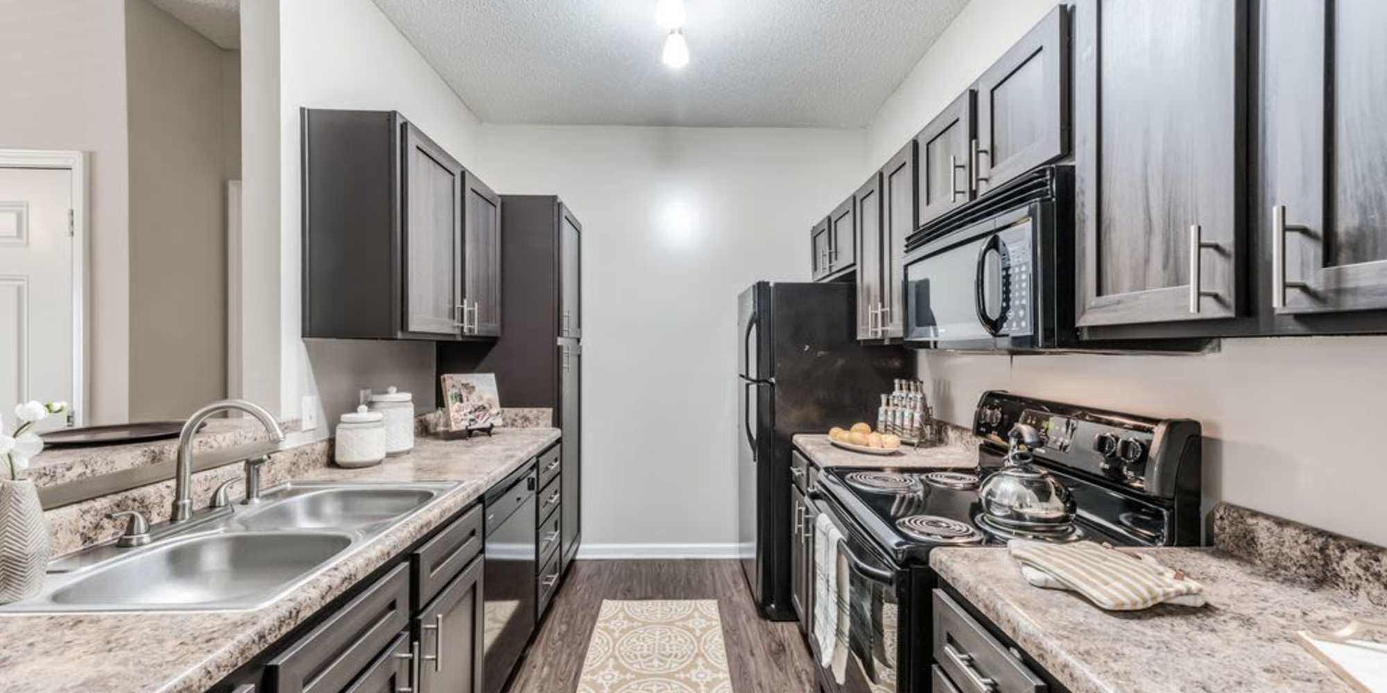 Model kitchen with modern appliances at The Landings of Conroe in Conroe, Texas