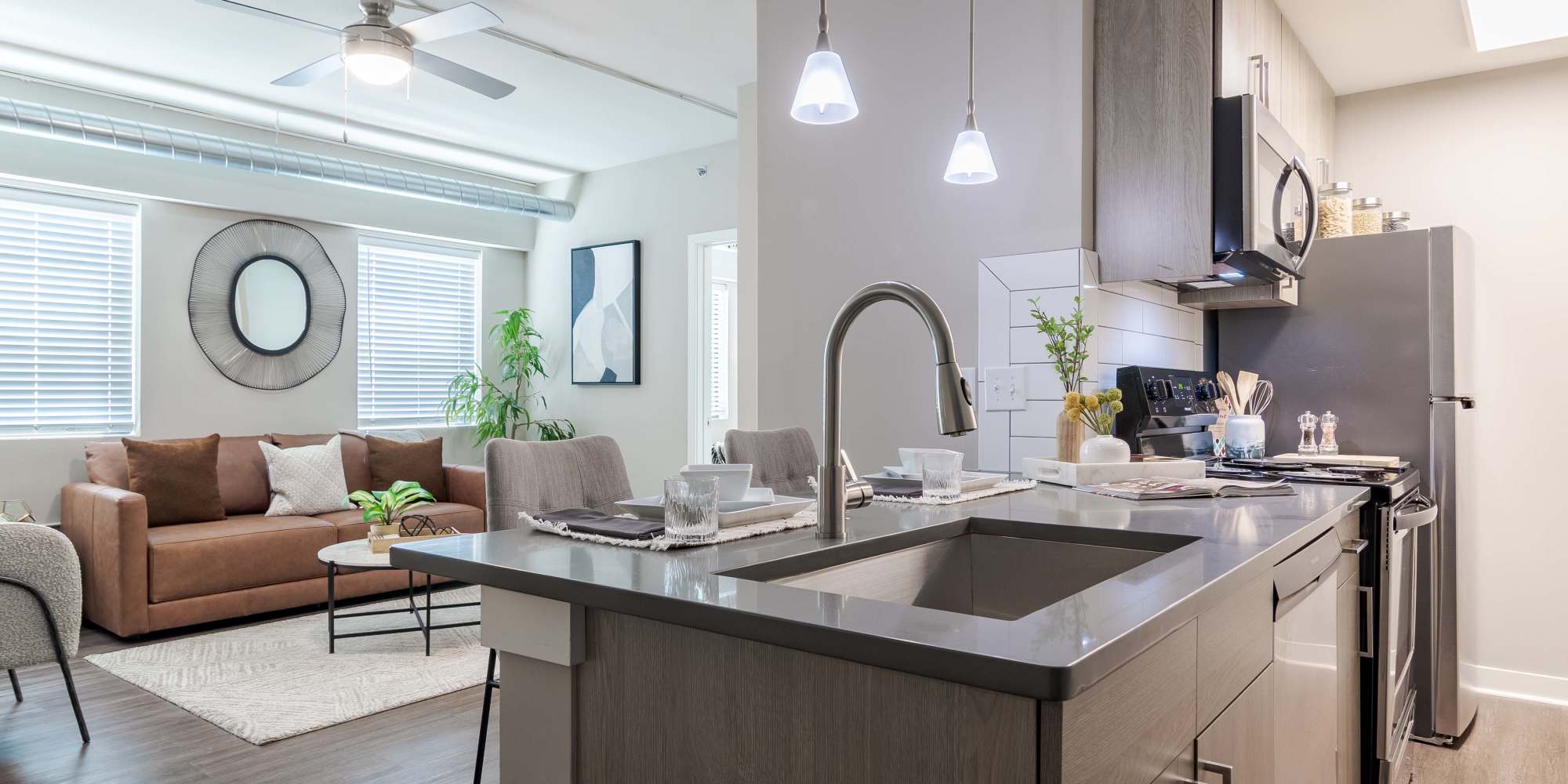 Open floor plan with a kitchen island at The Lofts at Twenty25 in Atlanta, Georgia