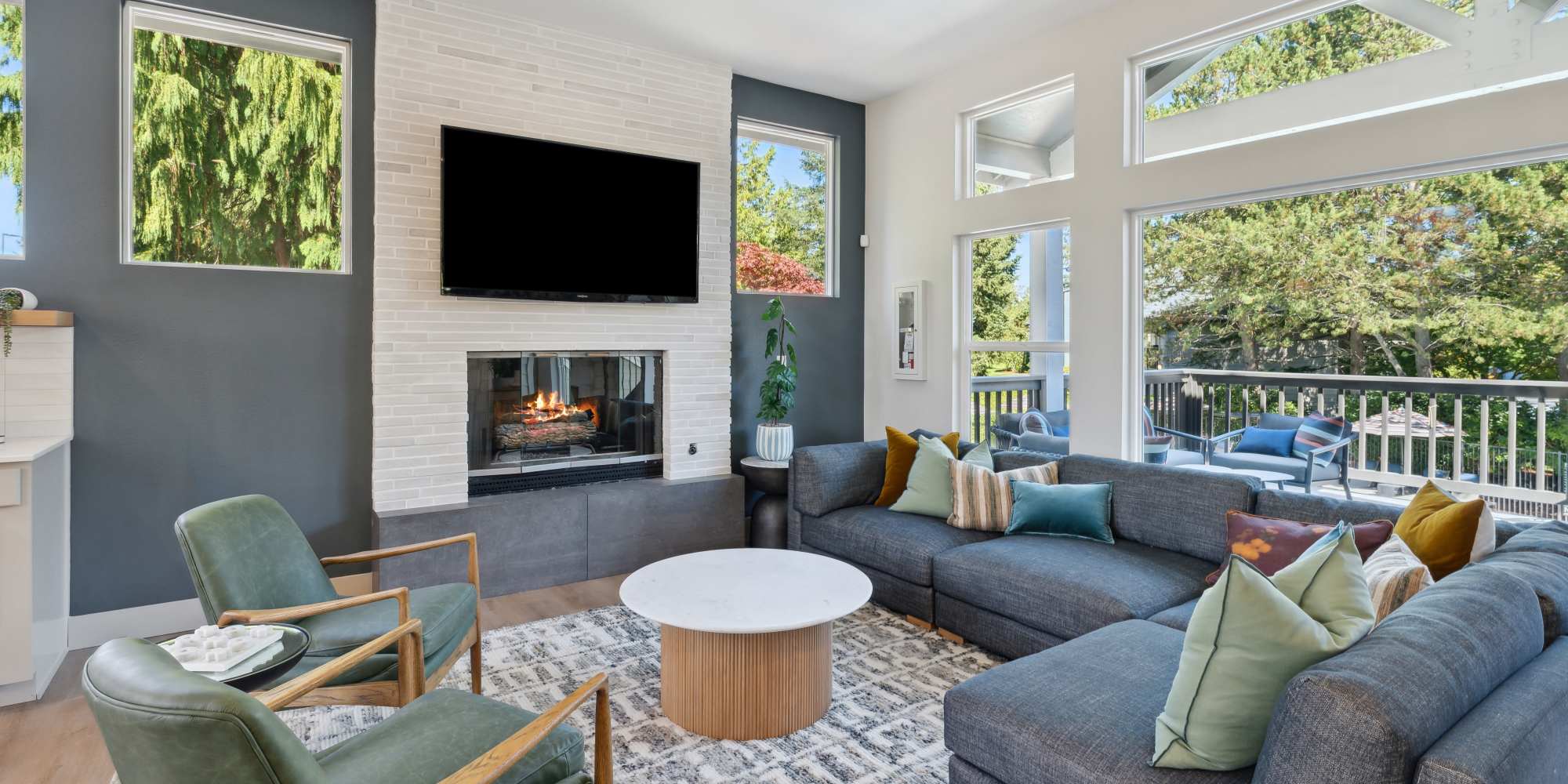 Model living room with fireplace at Madison Sammamish Apartments in Sammamish, Washington