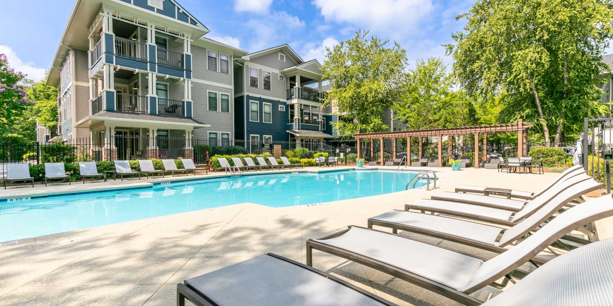 Pool area with loungers at The Reserve at Johns Creek Walk in Johns Creek, Georgia