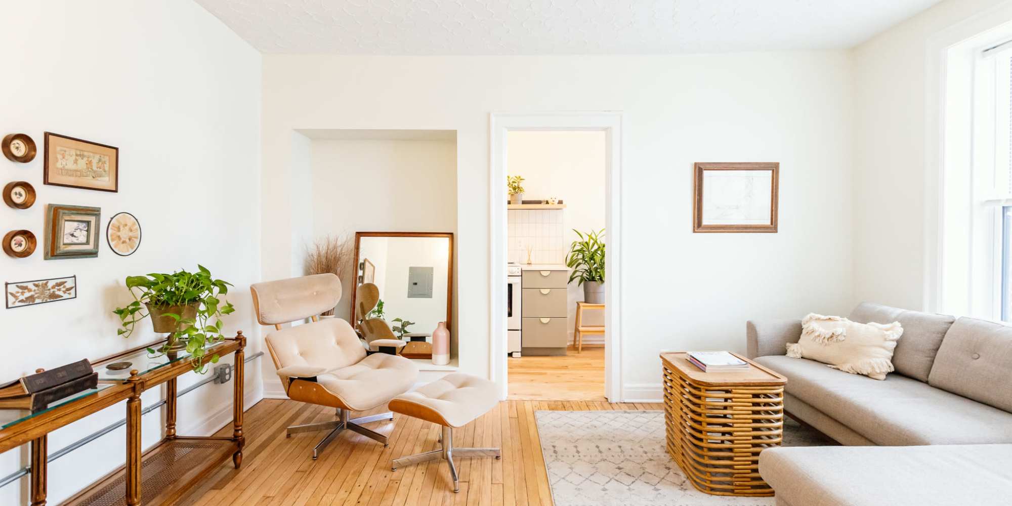 Spacious living room with couch and wood-style flooring at Detroit Living in Detroit, Michigan