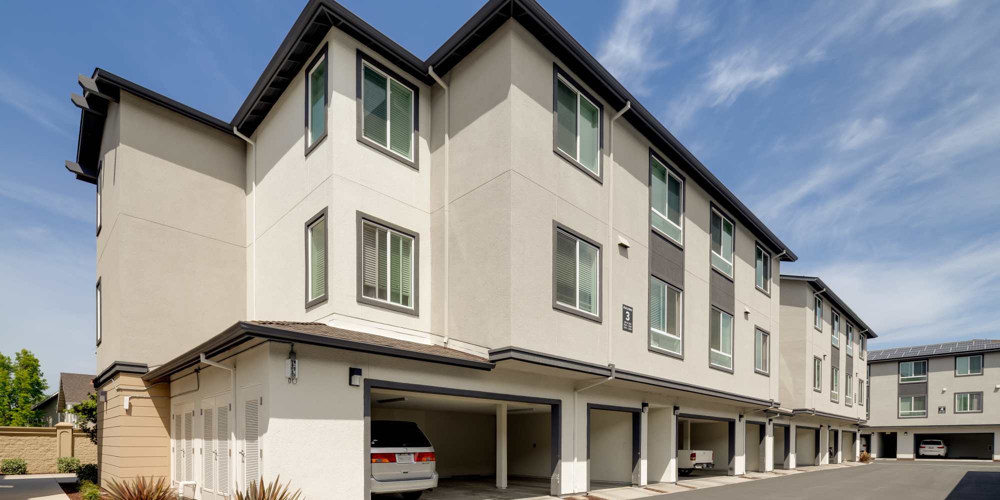 Building with garages on the ground floor at Village at First in Gilroy, California