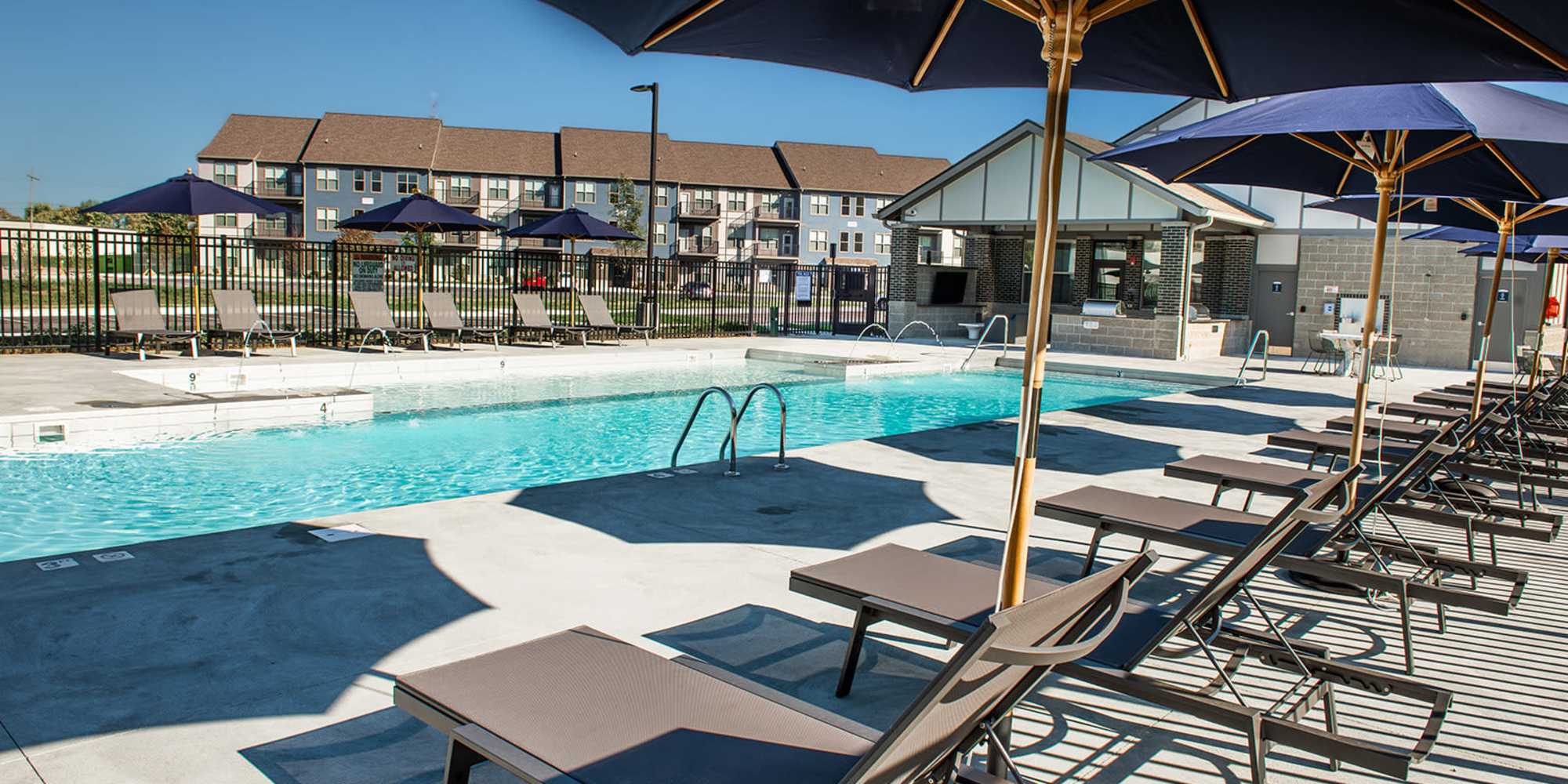 Swimming pool with lounge chairs at Founders Pointe Apartments in Franklin, Indiana