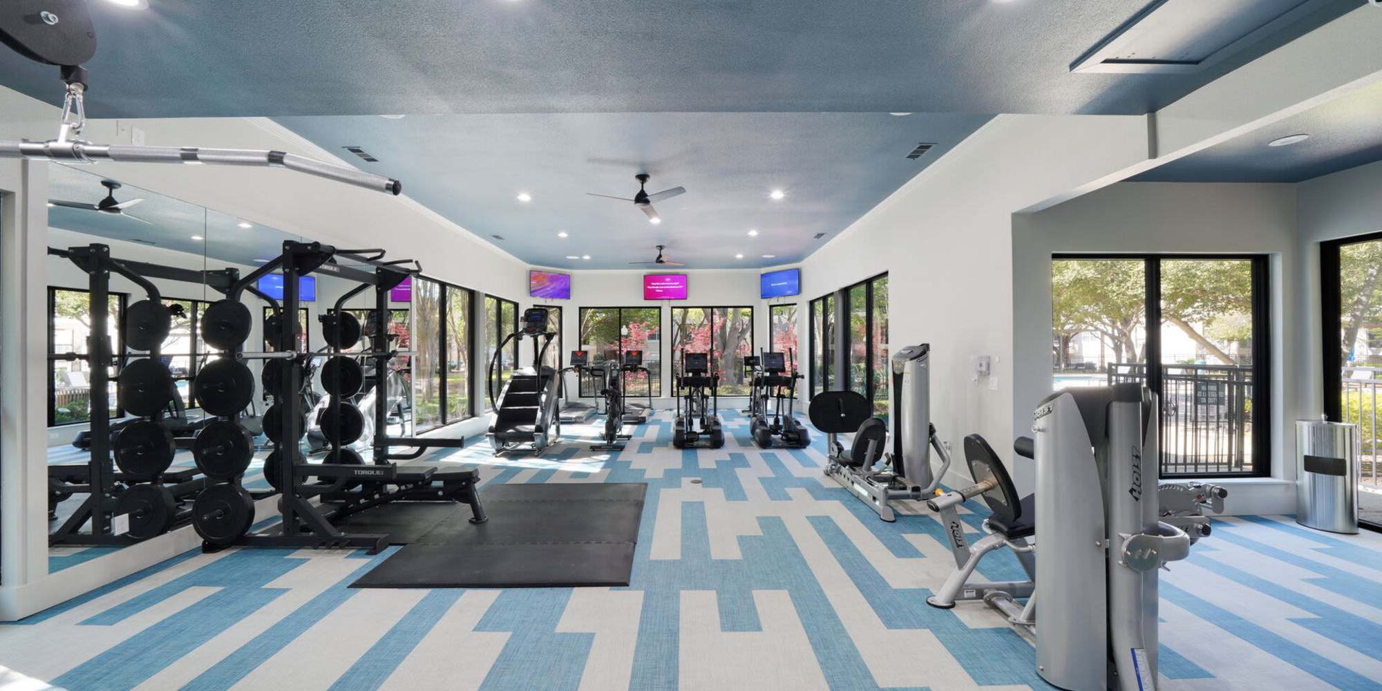 Fitness studio with treadmills and weight machines at St. Martin in Frisco, Texas, 
